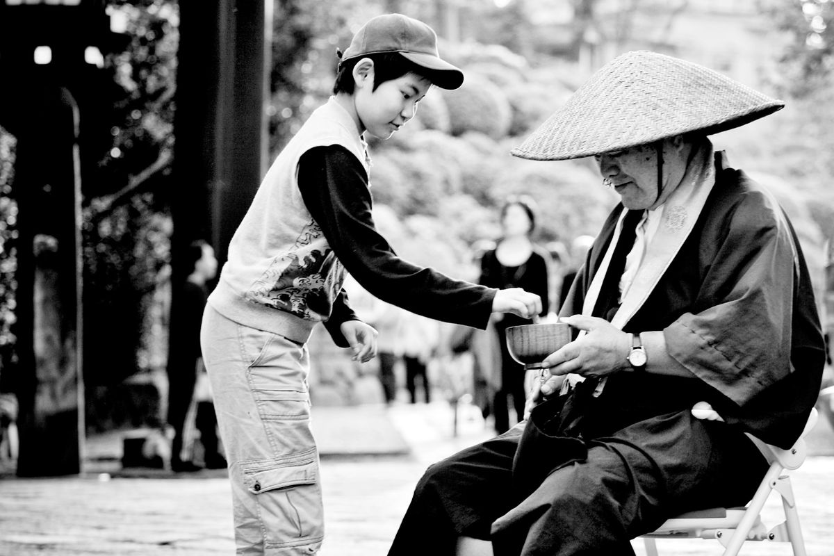 A Zen Buddhist monk in training practices Takuhatsu, or begging for alms. Nezu, Tokyo, Japan