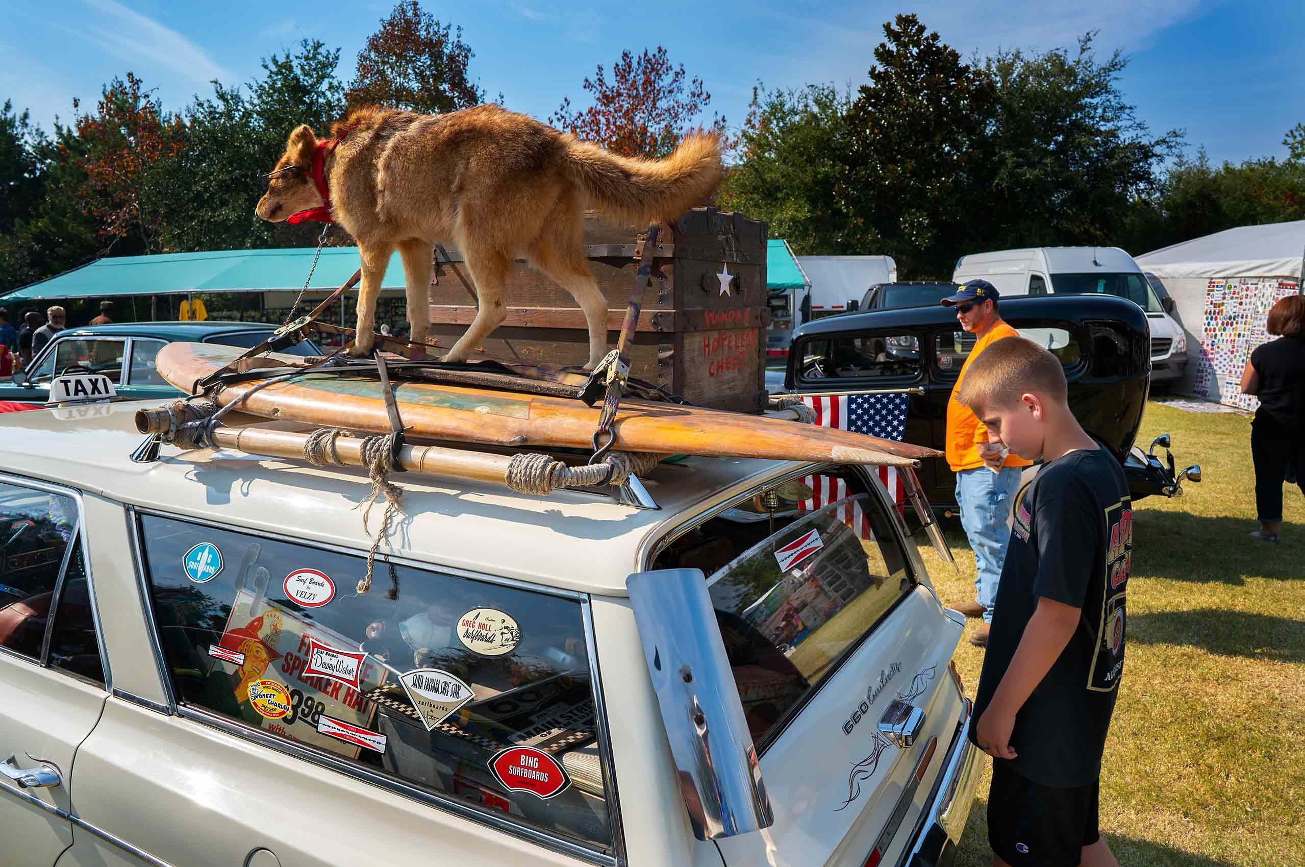 Kid at car show hot rod stuffed dog surf board 