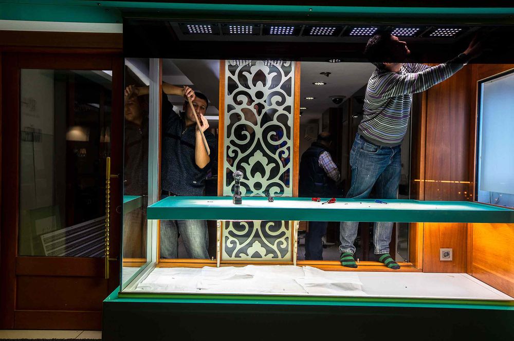 men working in a window in store in rome