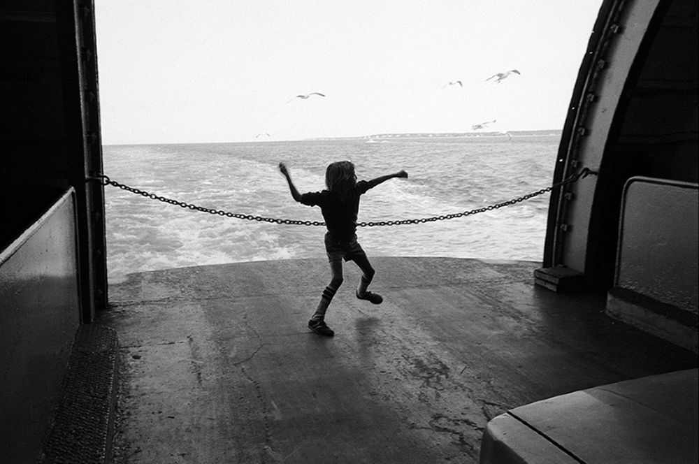 Boy feeding gulls Martha's vineyard ferry B&W street photography 1981  nineteen  seventies