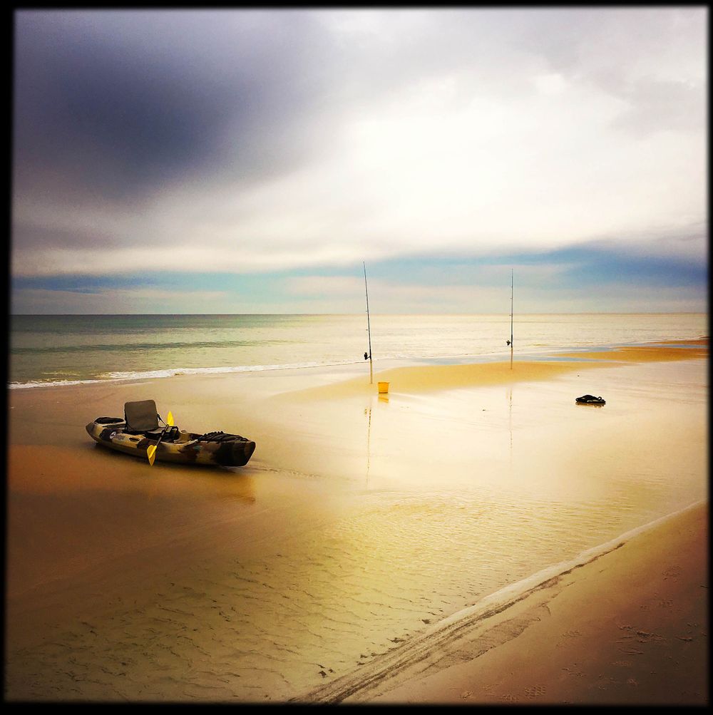 Fishing Kayak ashore in Blue Mountain Beach in the panhandle of flordia 