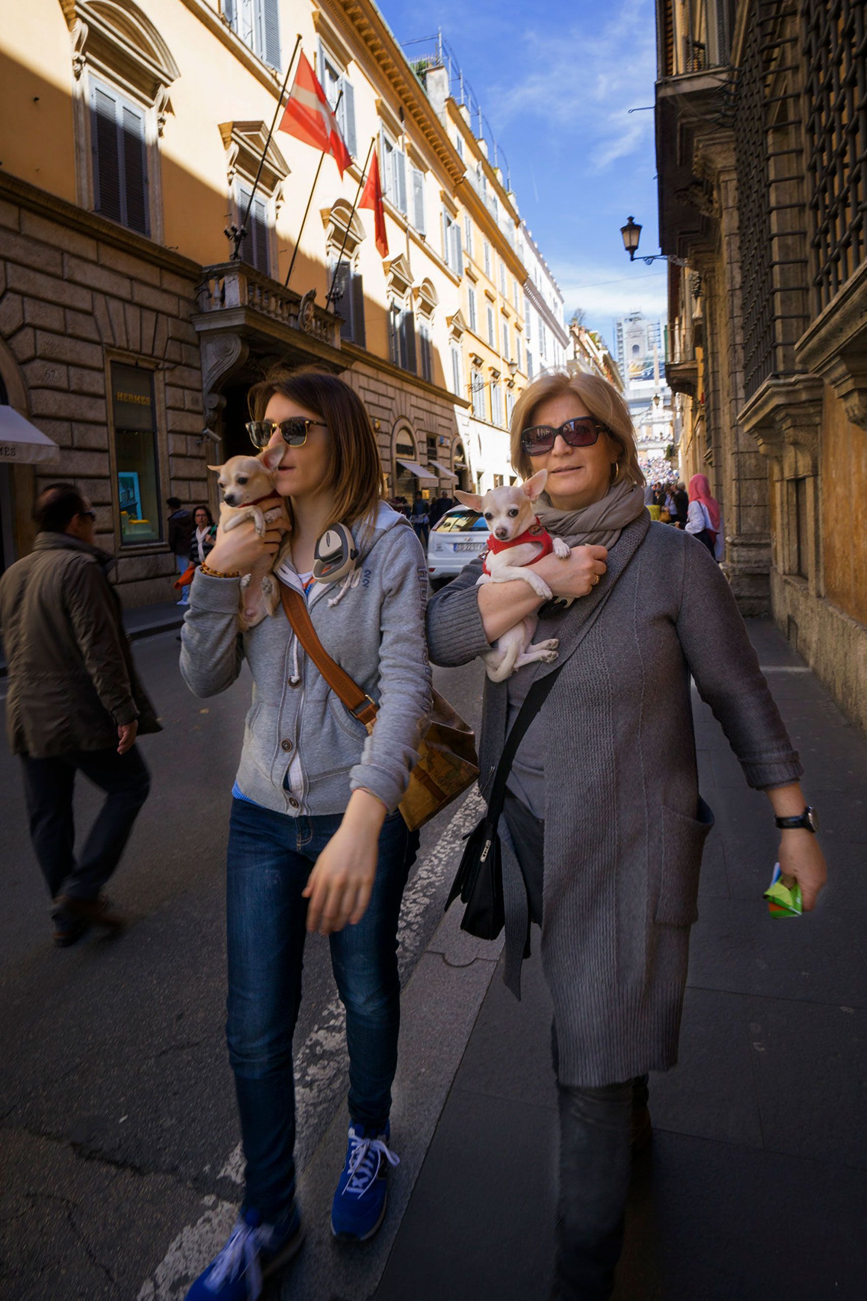Mother and daughters with thiner little dogs Rome Italy 