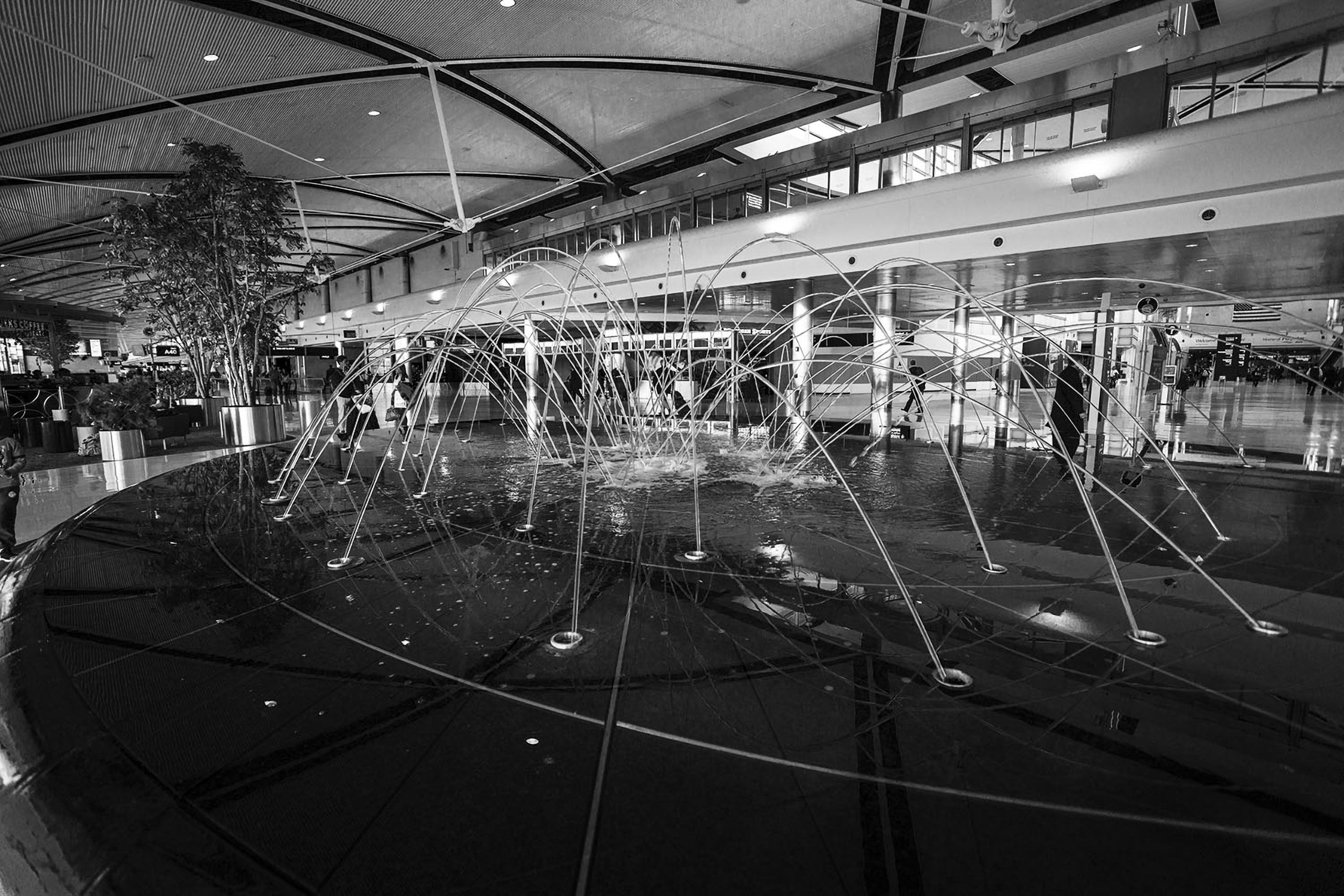 Inspired by the lines of a flight map, the 39 ft. wide fountain designed by WET ... A at the McNamara Terminal building, Detroit Metropolitan Airport's underground 