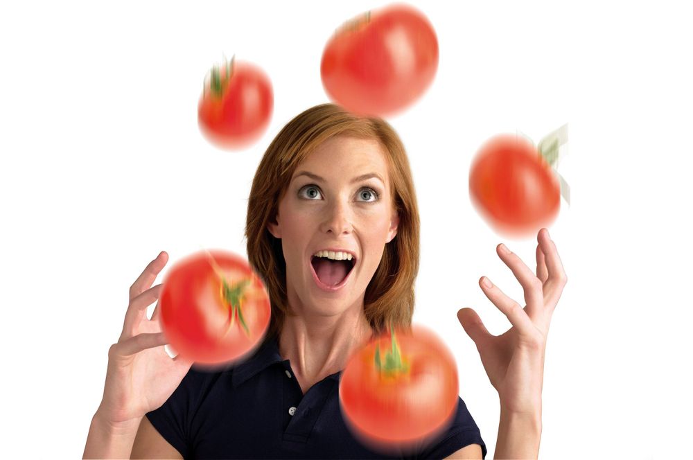 Woman juggling tomatoes adverting commercial photograph