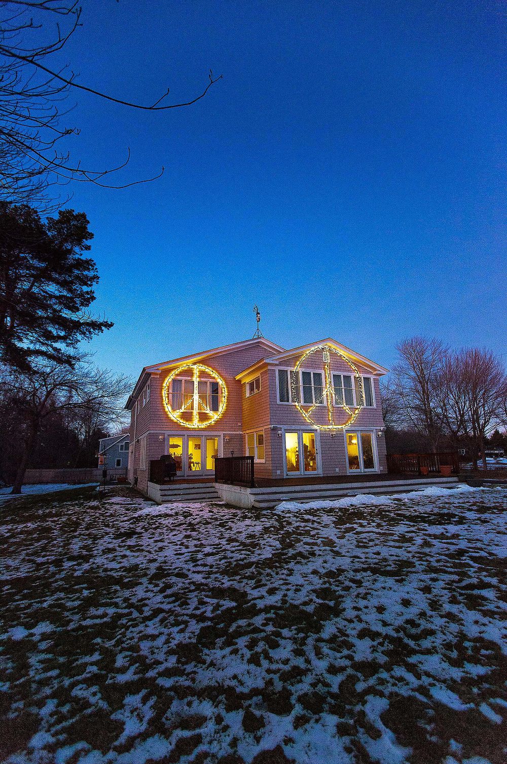 Large Peace sign signs on house in Cape Elizabeth Maine