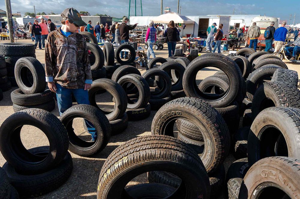 car show by Maule Air Inc in  moultrie Georgia kid looking at tires miffie holiday in backreound
