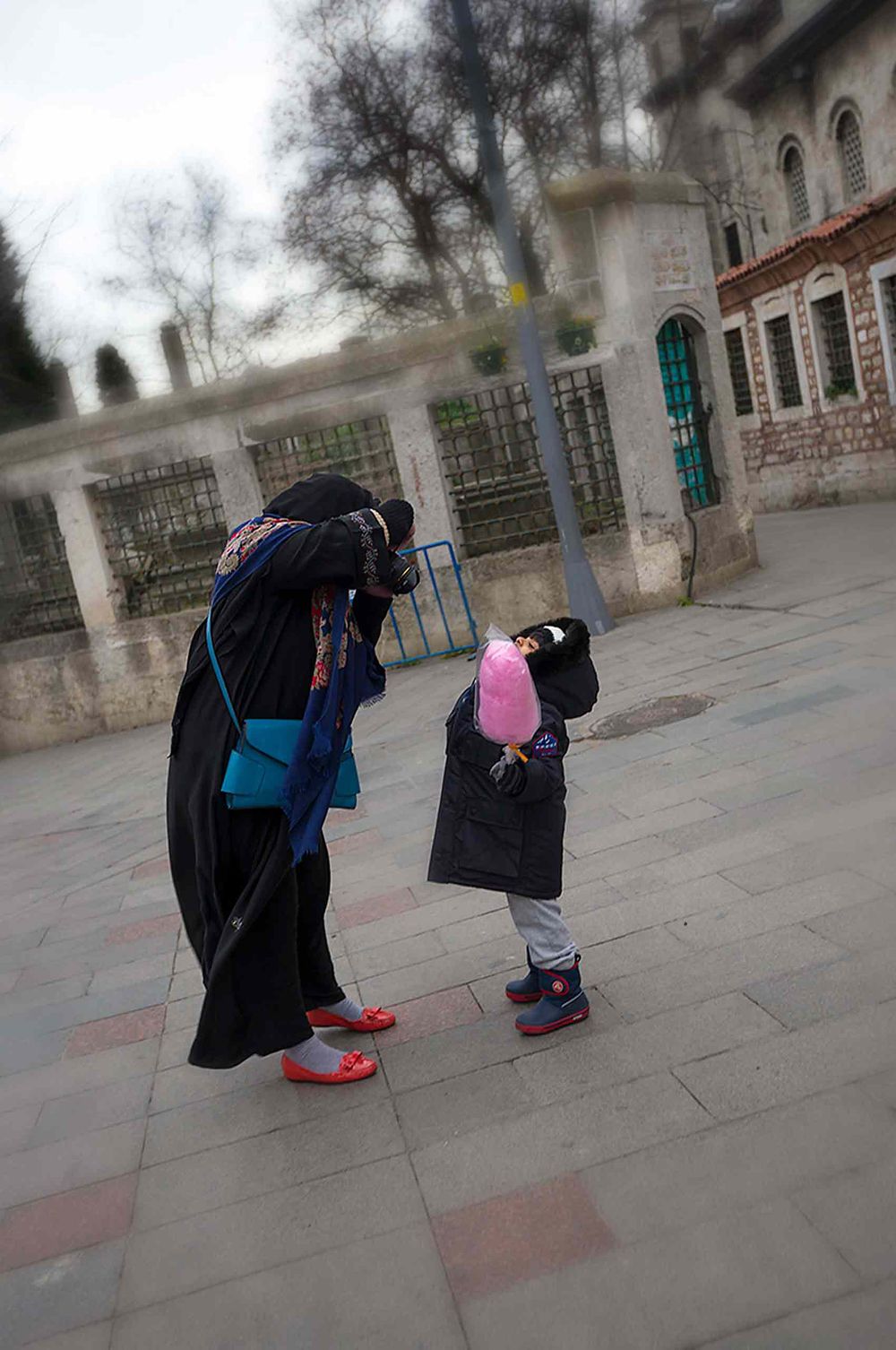 Mom photographing kid with cotton candy in Istanbul Turkey