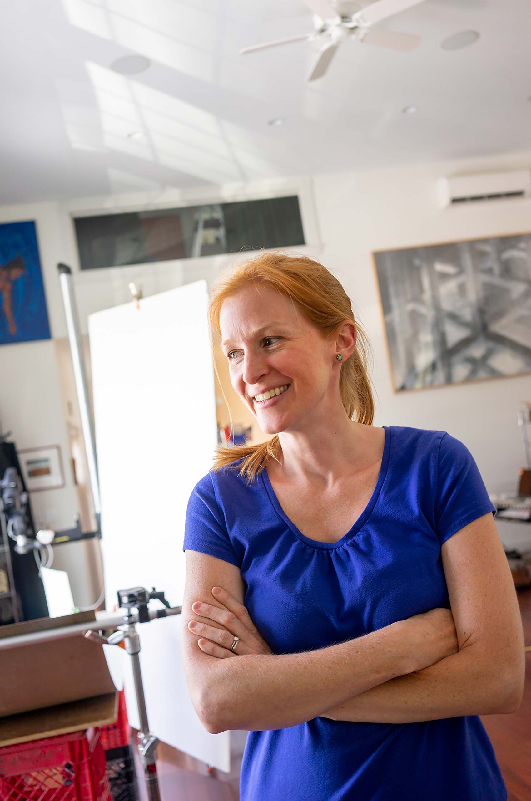 Art director at photoshoot in Warren Roos daylight studio  redhead woman 