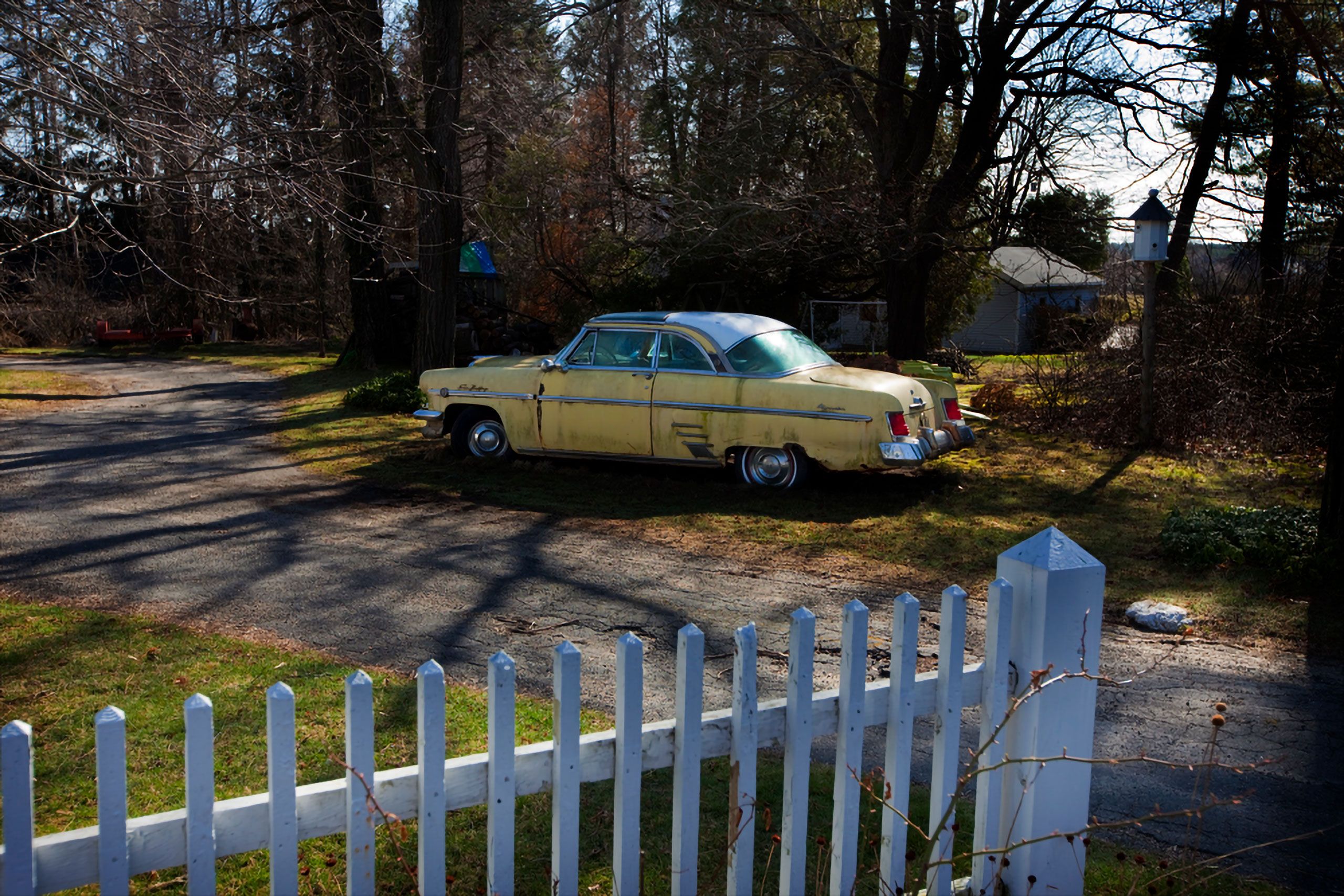 old yellow car by picket fence scarbrough maine