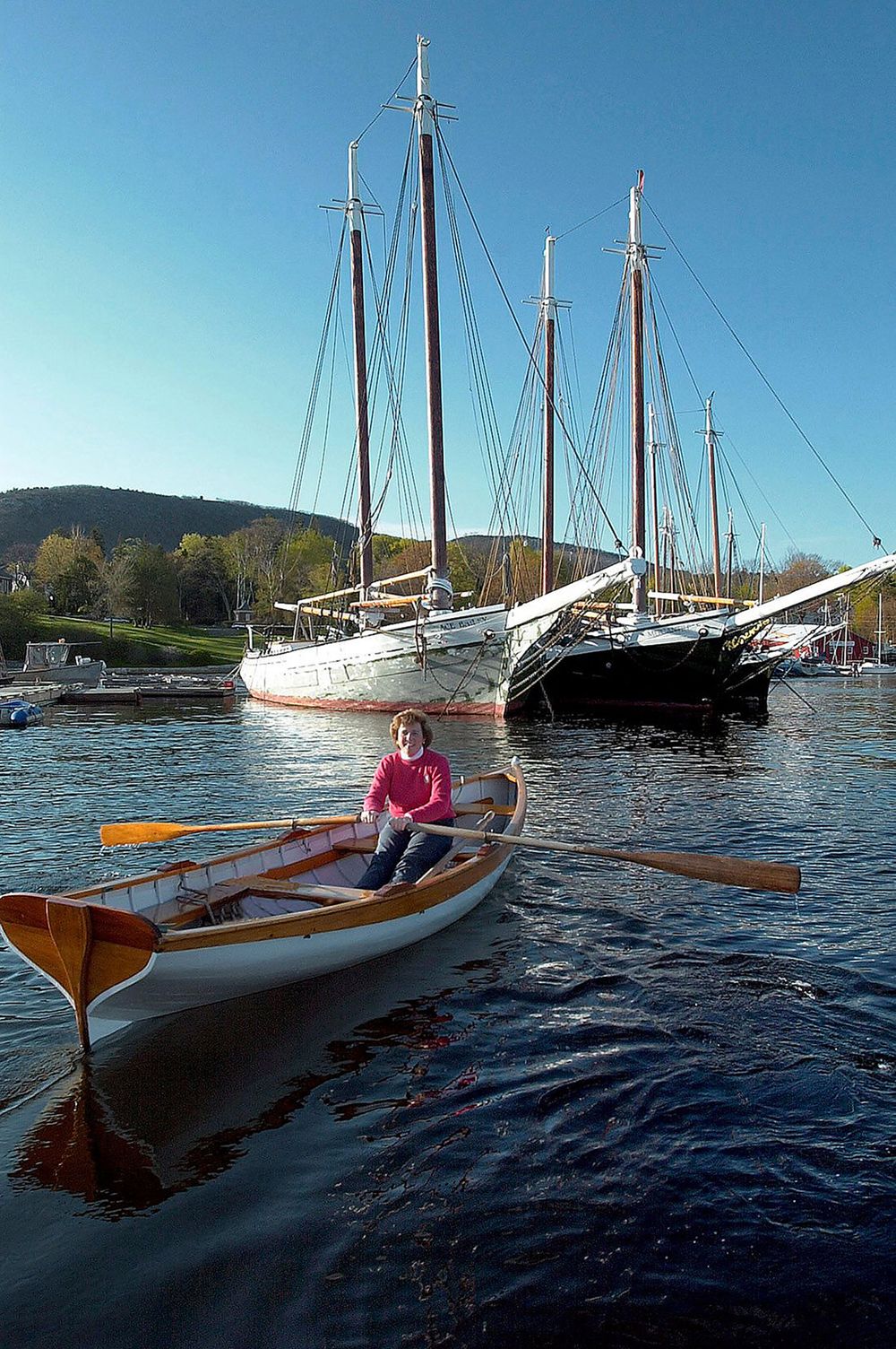 Bank President rowing a skiff in Camden harbor for a annual report photoshoot