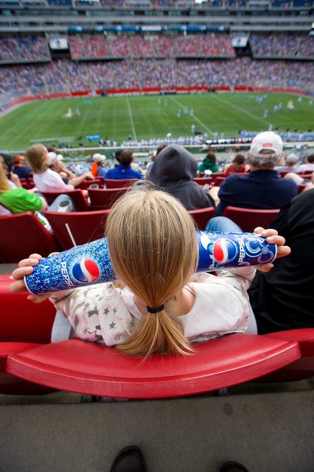 Girl bored at NCAA Men's lacrosse puts cups over her ears