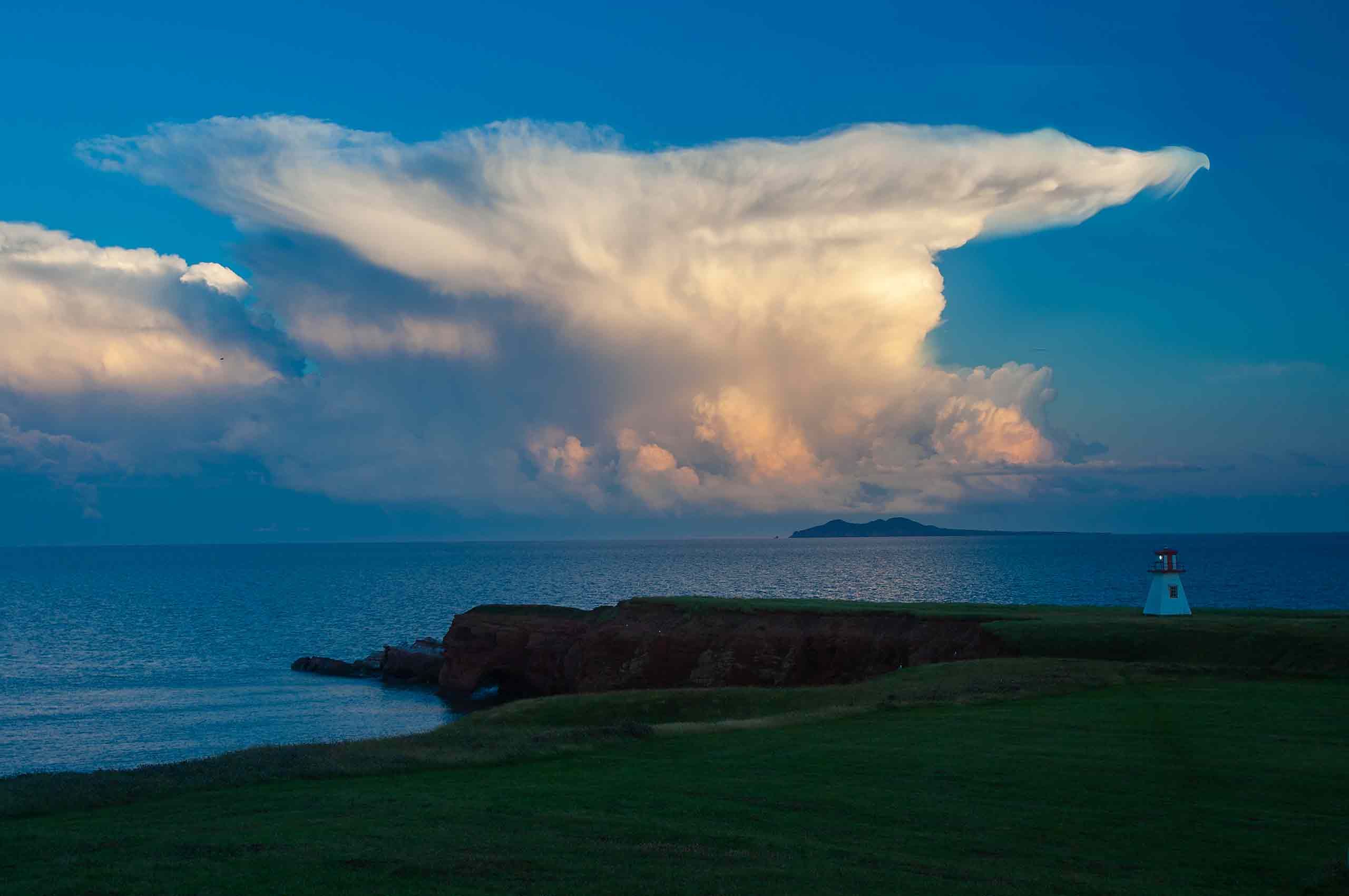 Giant thunder head cloud Magdalen Islands Îles de la Madeleine harve mason Quebec small working lighthouse