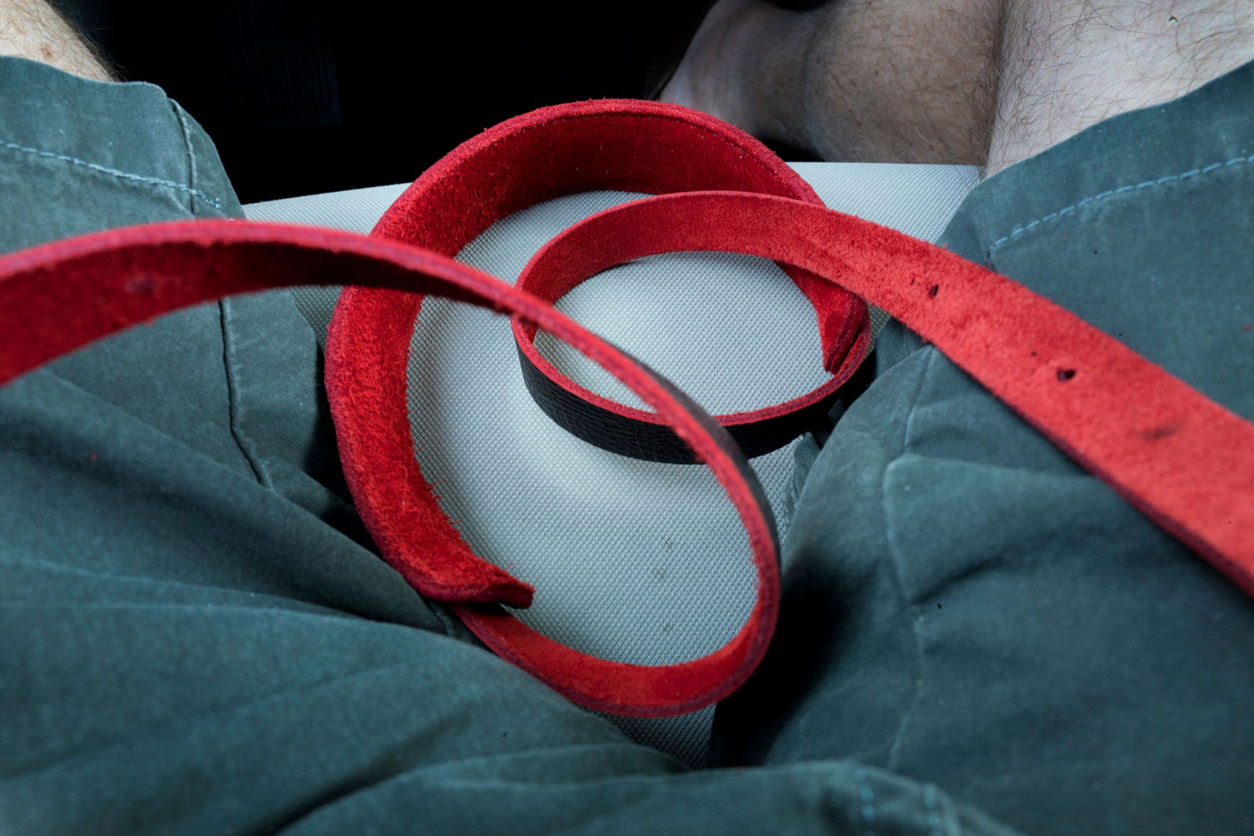 red camera strap in lap of warren roos ready to pounce