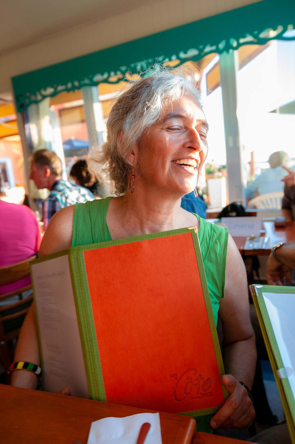 Shelley Pomerance and menu woman smile Cafe de Caote  Les Îles-de-la-Madeleine,  Canada Quebec summer