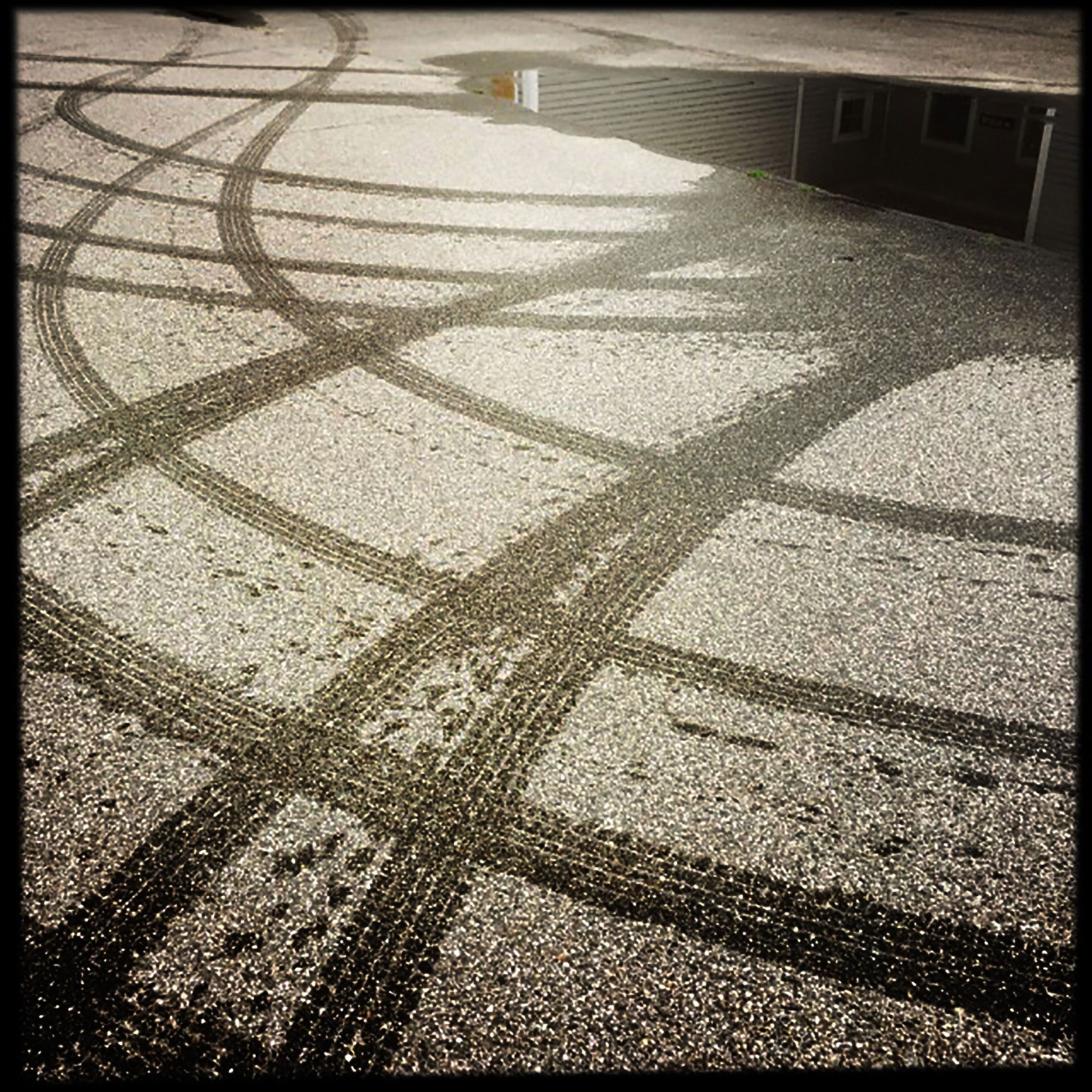 Tire tracks on road in from of warren roos photography studio south Portland Maine