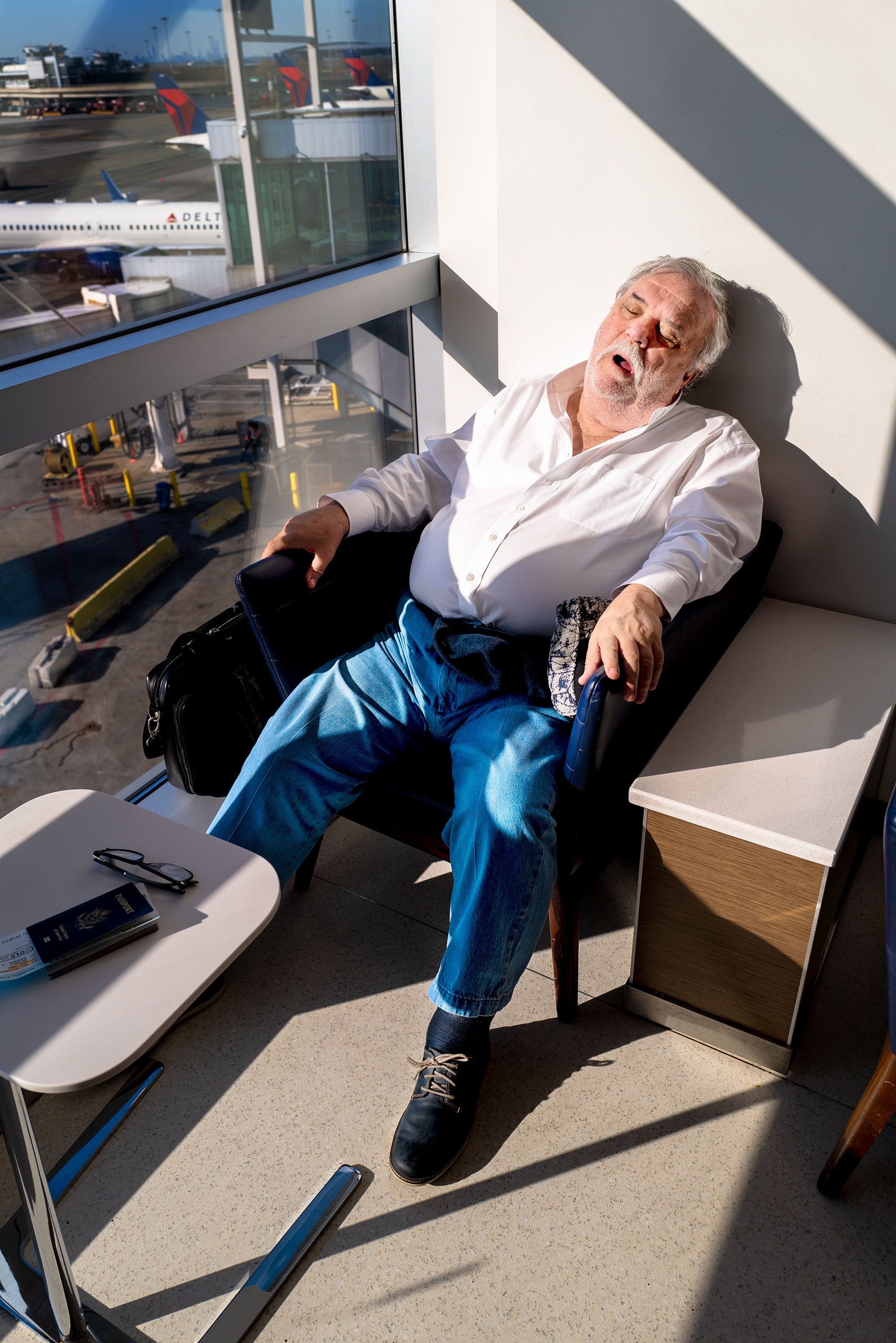 sleeping in sun Delta lounge at JFK