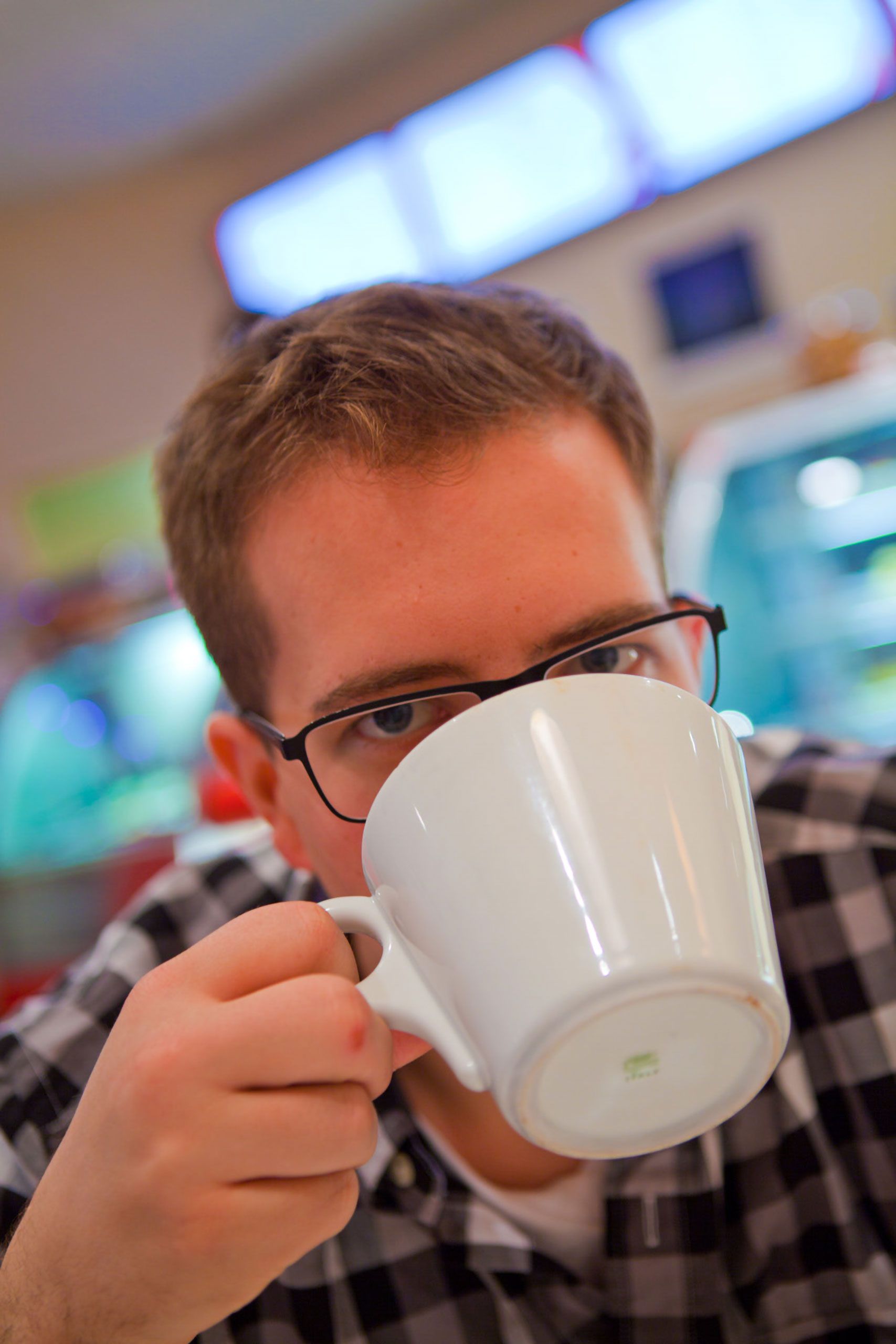 sam roos drinking a cup of coffee austin texas
