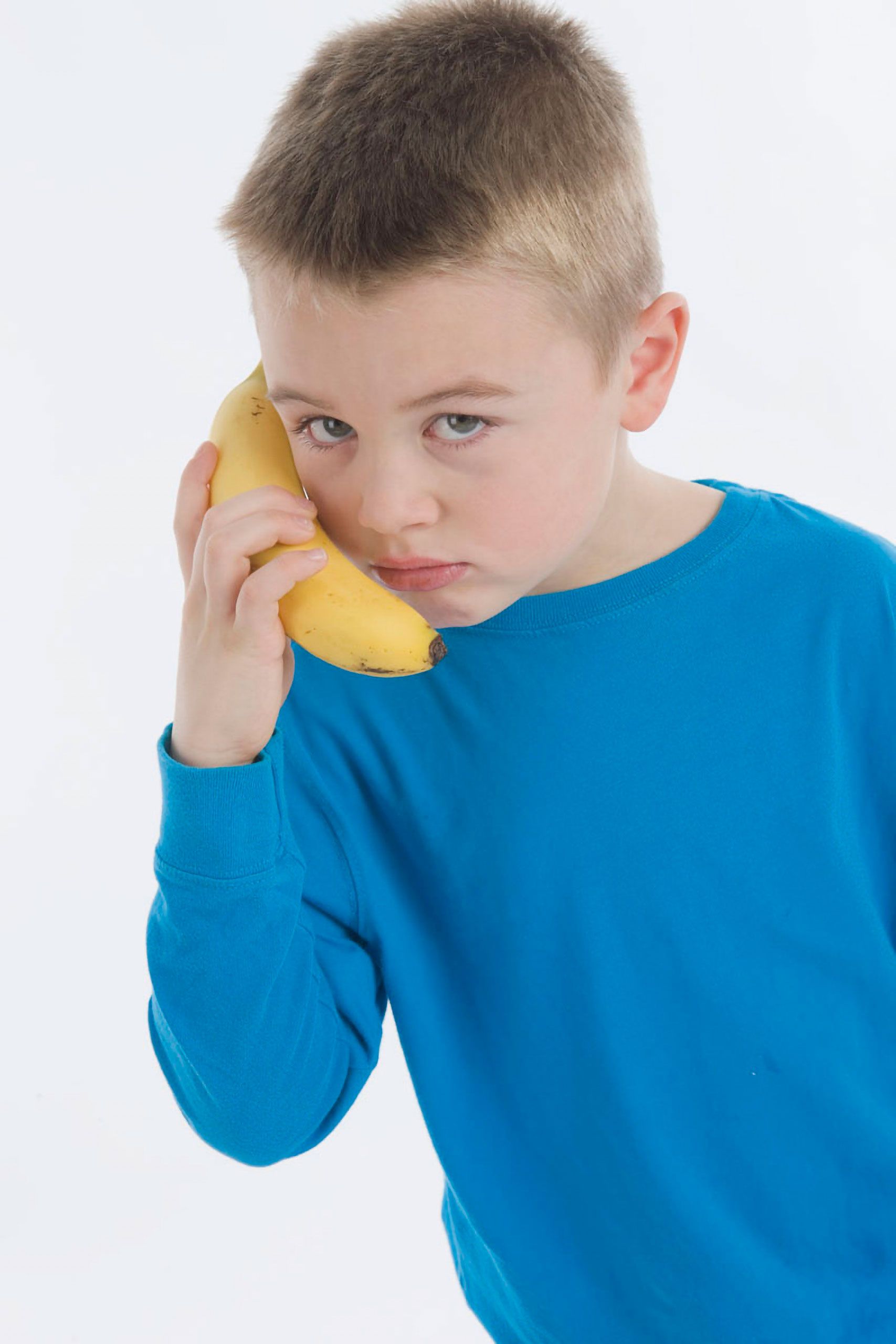 commercial studio advertising photoshoot  young boy taking on banana telephone 