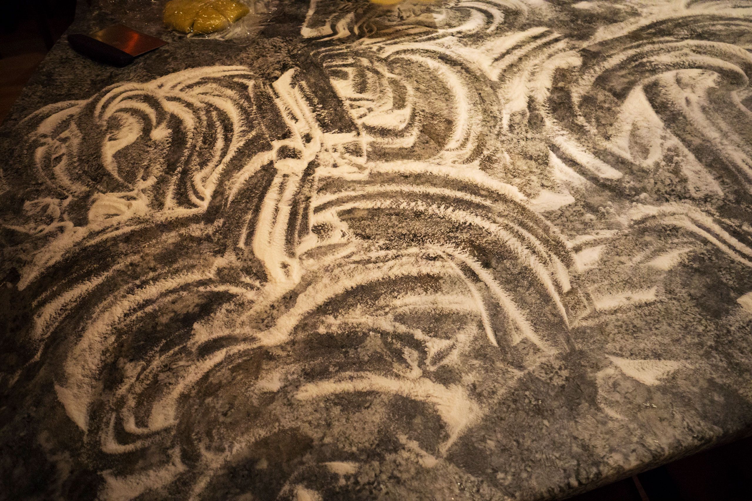 Nice swirls and lines in flour on a counter for an advertising  photoshoot warren roos 