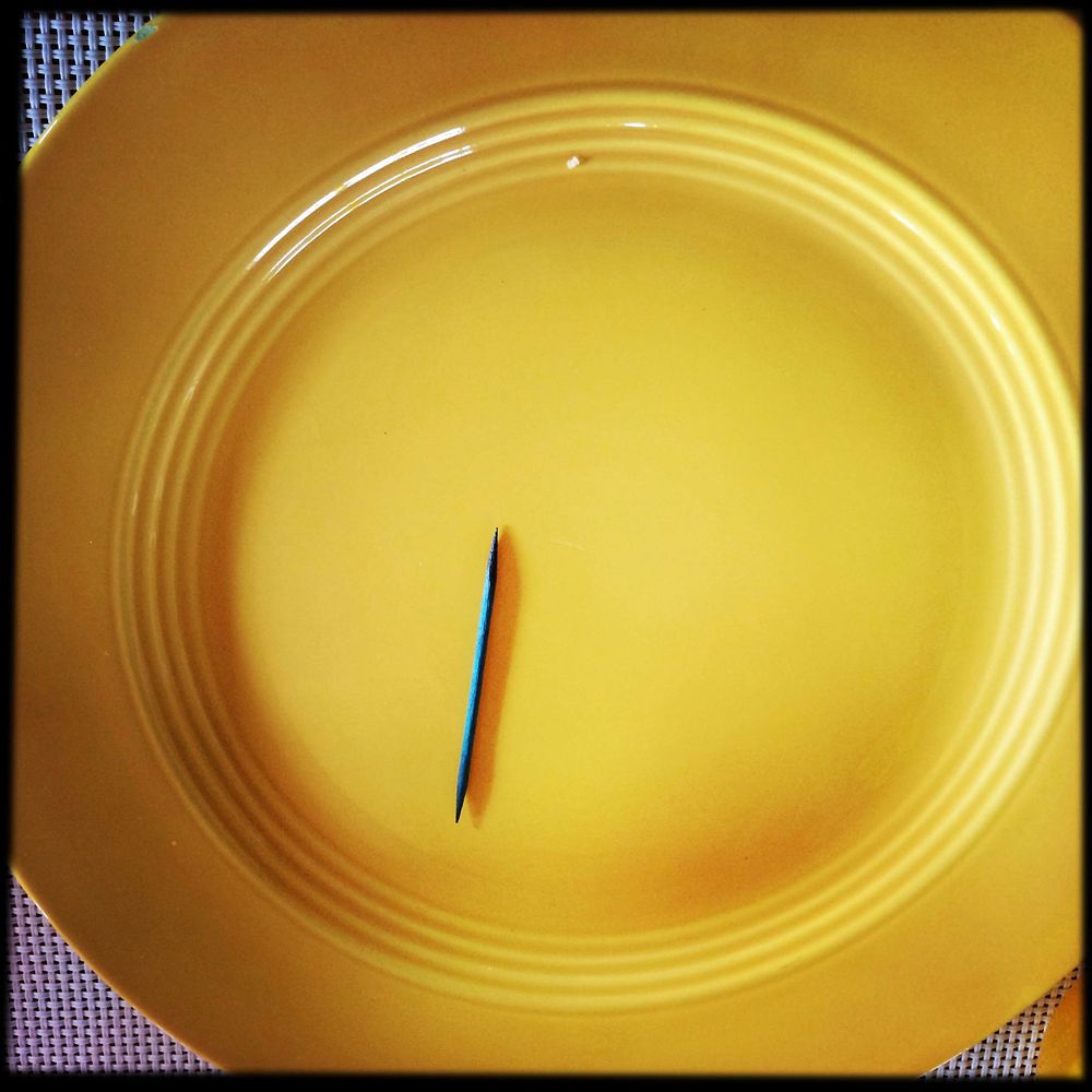blue toothpick on yellow plate