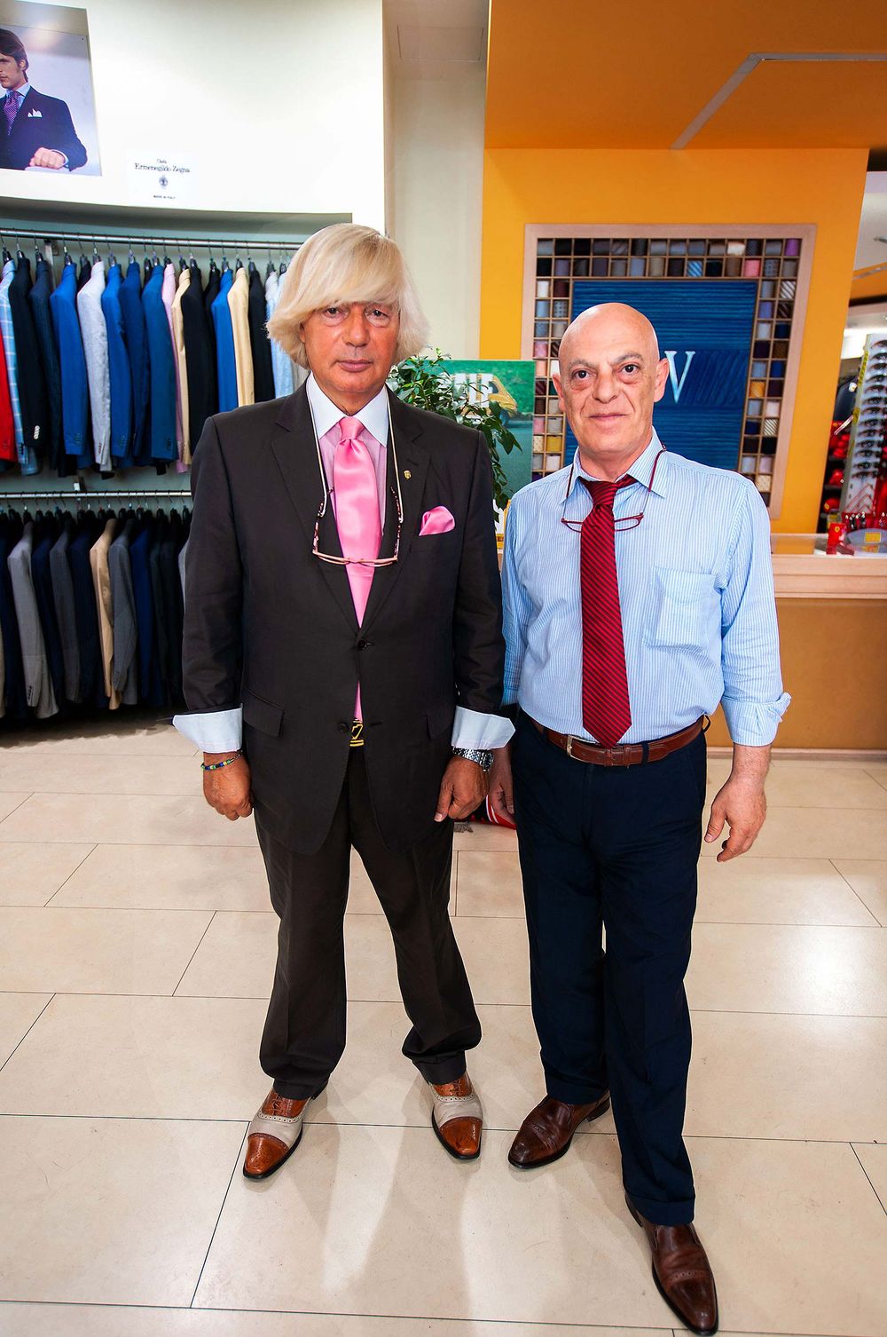 Two sales men in Rome Italy clothing store fashion suit bald mop top dadny