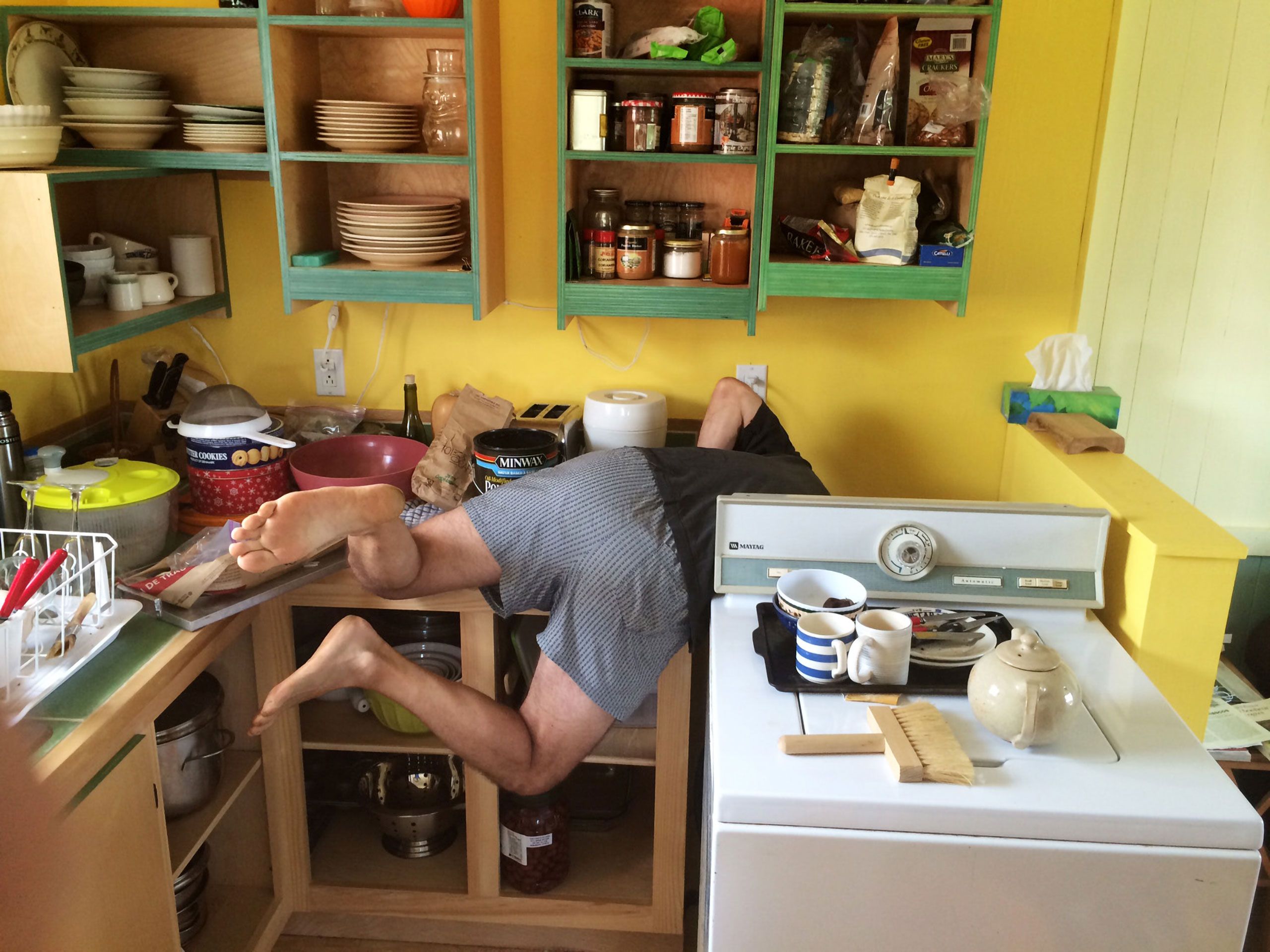 Gilbert Boyer diving behind stove  Magdalen Islands Îles de la Madeleine Quebec Canada  Harve Aubert