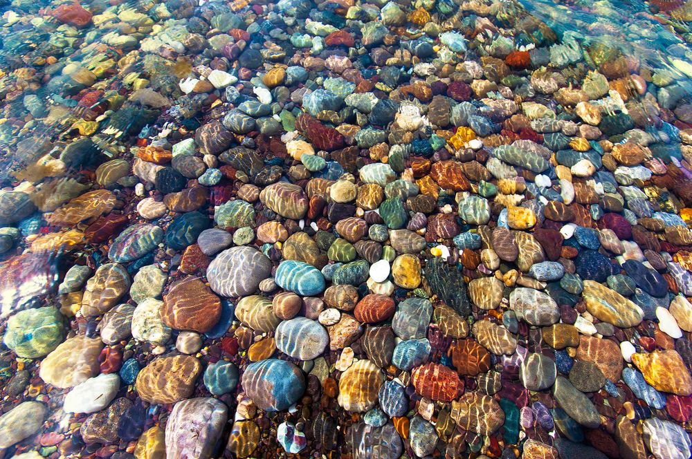 Colored and striped lucky Rocks in the water at a secret location in  les Îles de la Madeleine 