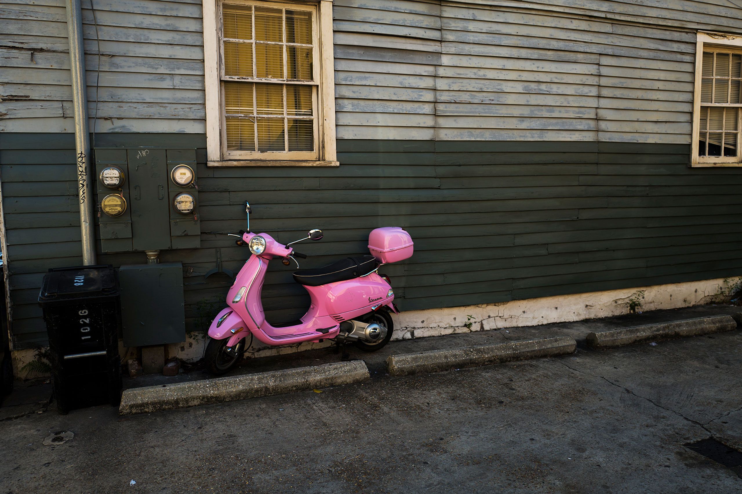 Pink moped by green wall NOLA