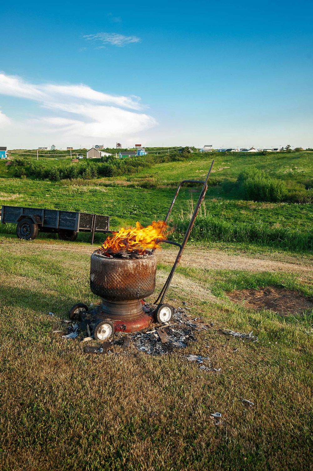 Fire in daytime in a washing machine  tub atop a lawnmower iles de la madeleine harve aubert one of lives great mysteries