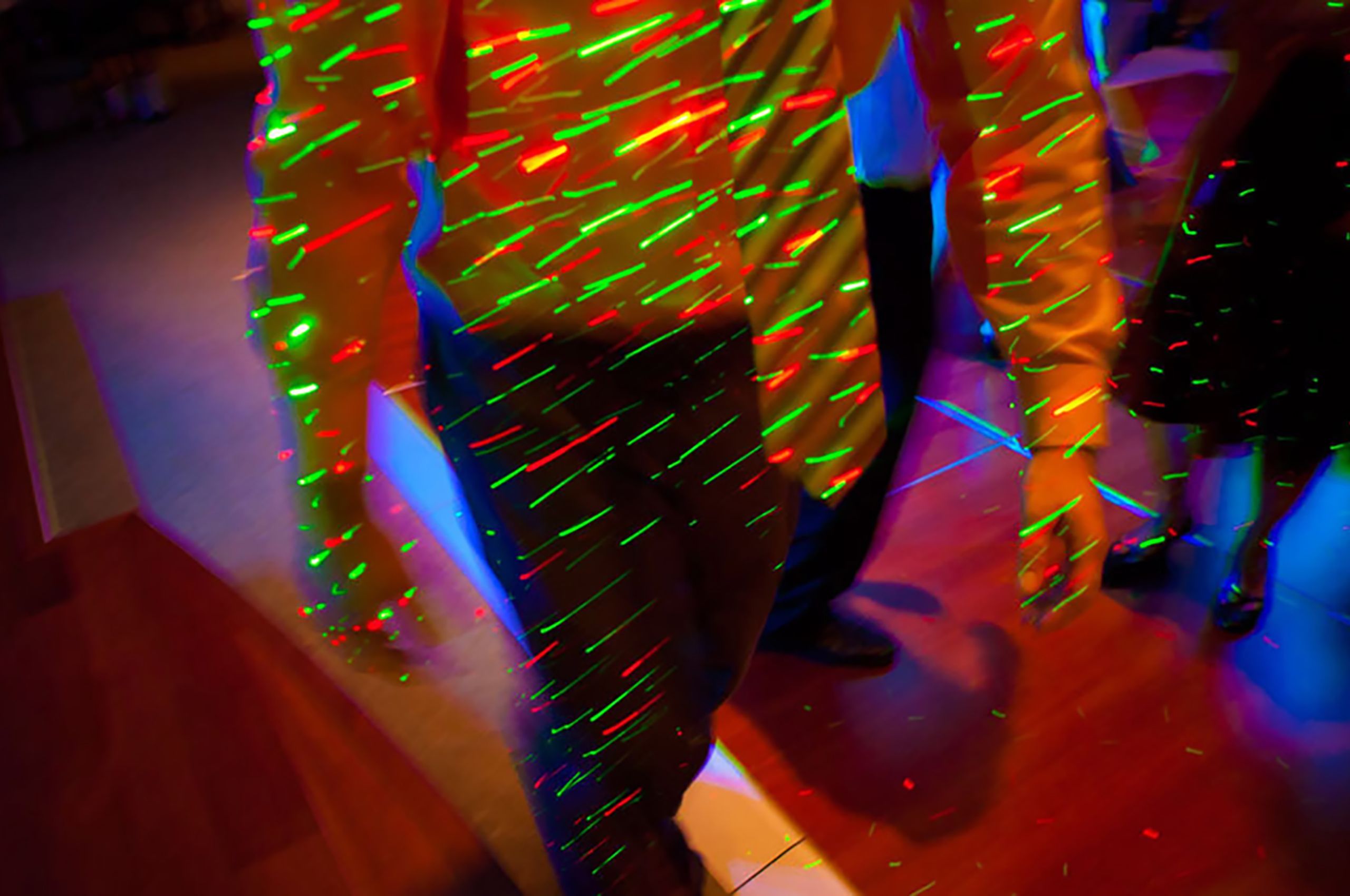 Guy with a tie at a party light show