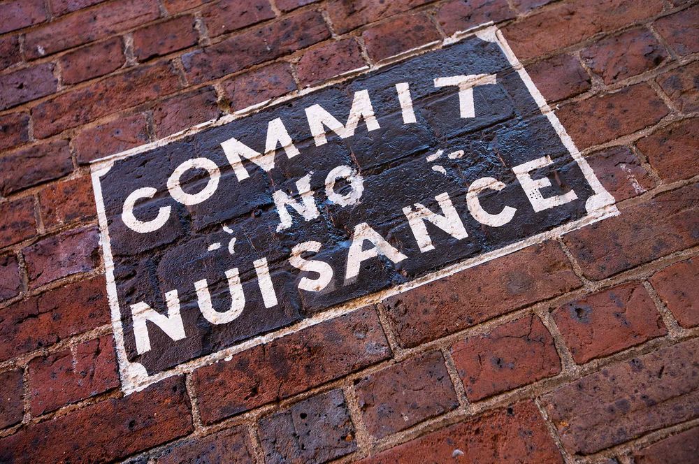 Commit no nuisance sign on wall in Barbados
