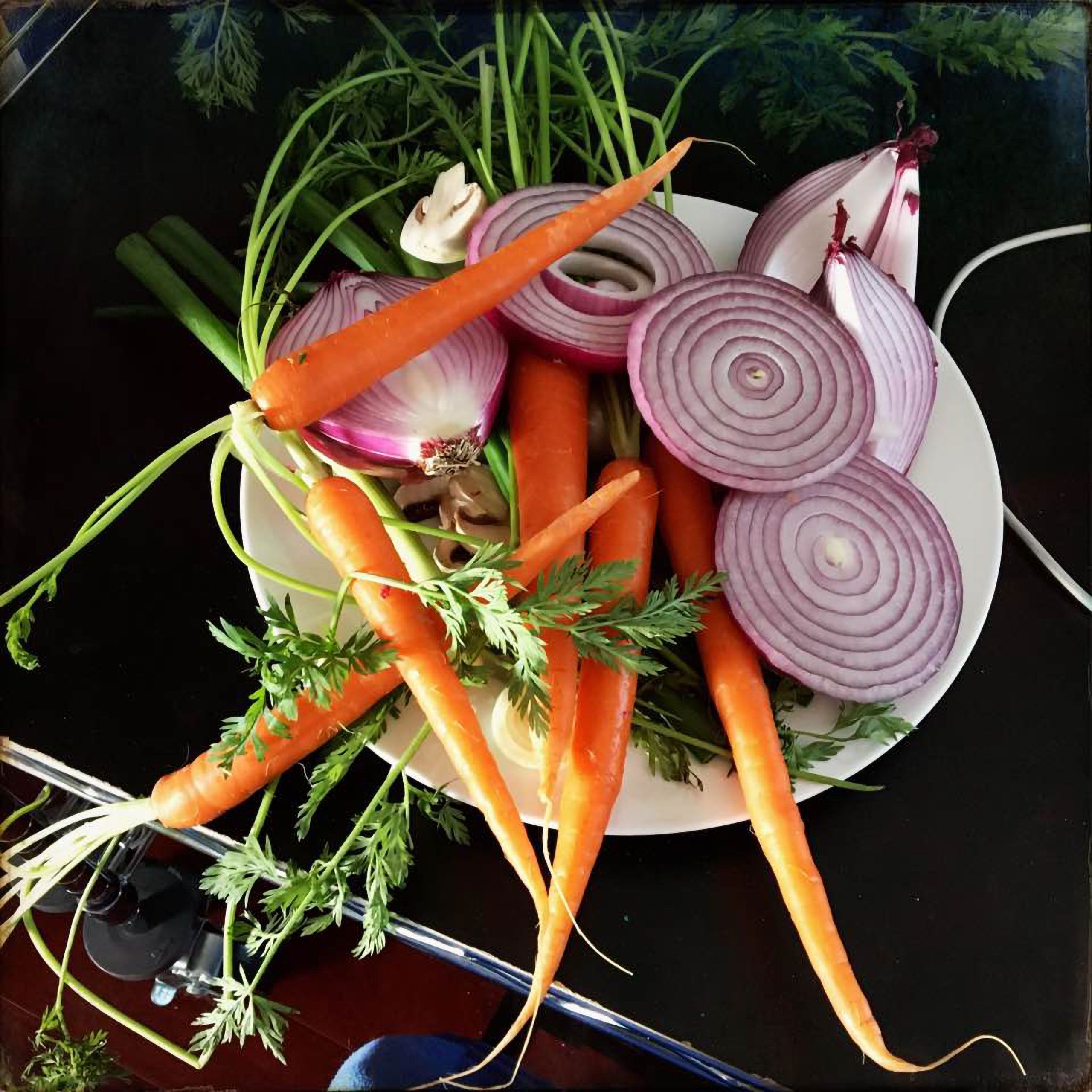 Carrots and red bermuda onions on the side of a set at an advertising photoshoot  from photographer warren  roos