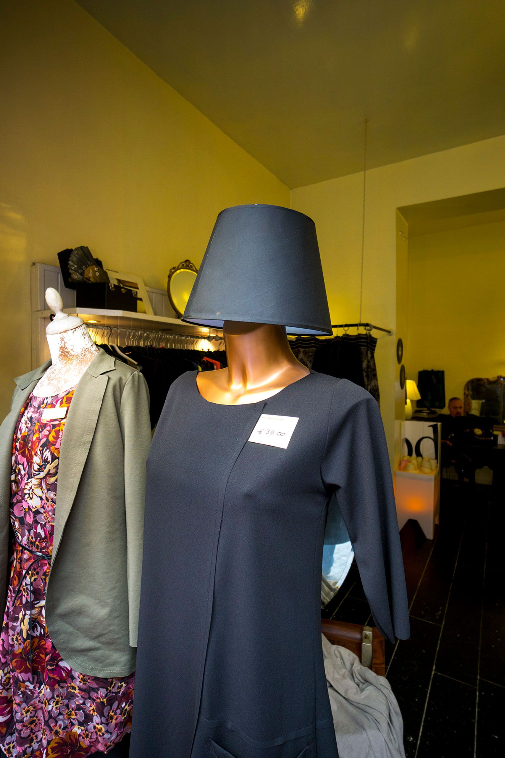 Lamp shade on head in a store winnow Rome  store window 