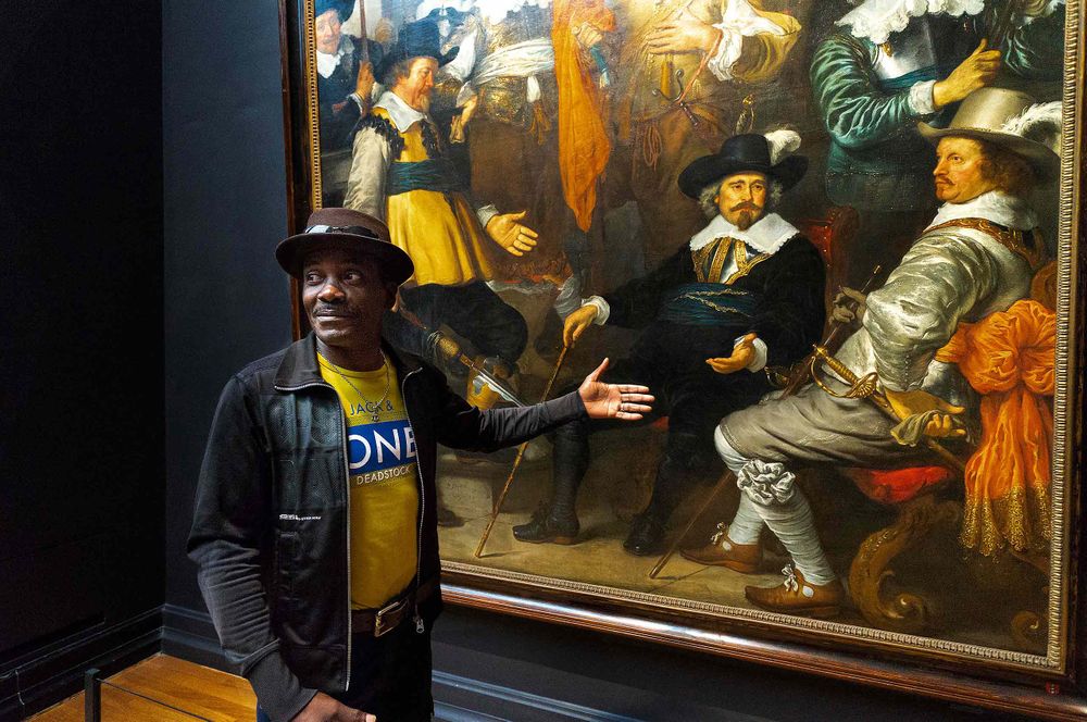 man mimicking a painting at the  Rijksmuseum,cAmsterdamcNetherlands.  rembrandt