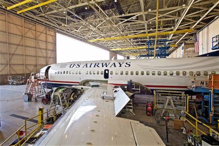 A wide body USAir plane sits in a maintenance hanger USAir Plane Inside a Hanger