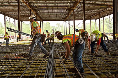 Men from a local union installing rebar to the floor of SolarCity, a large solar manufacturing facility in Buffalo, NY. Men Installing Rebar