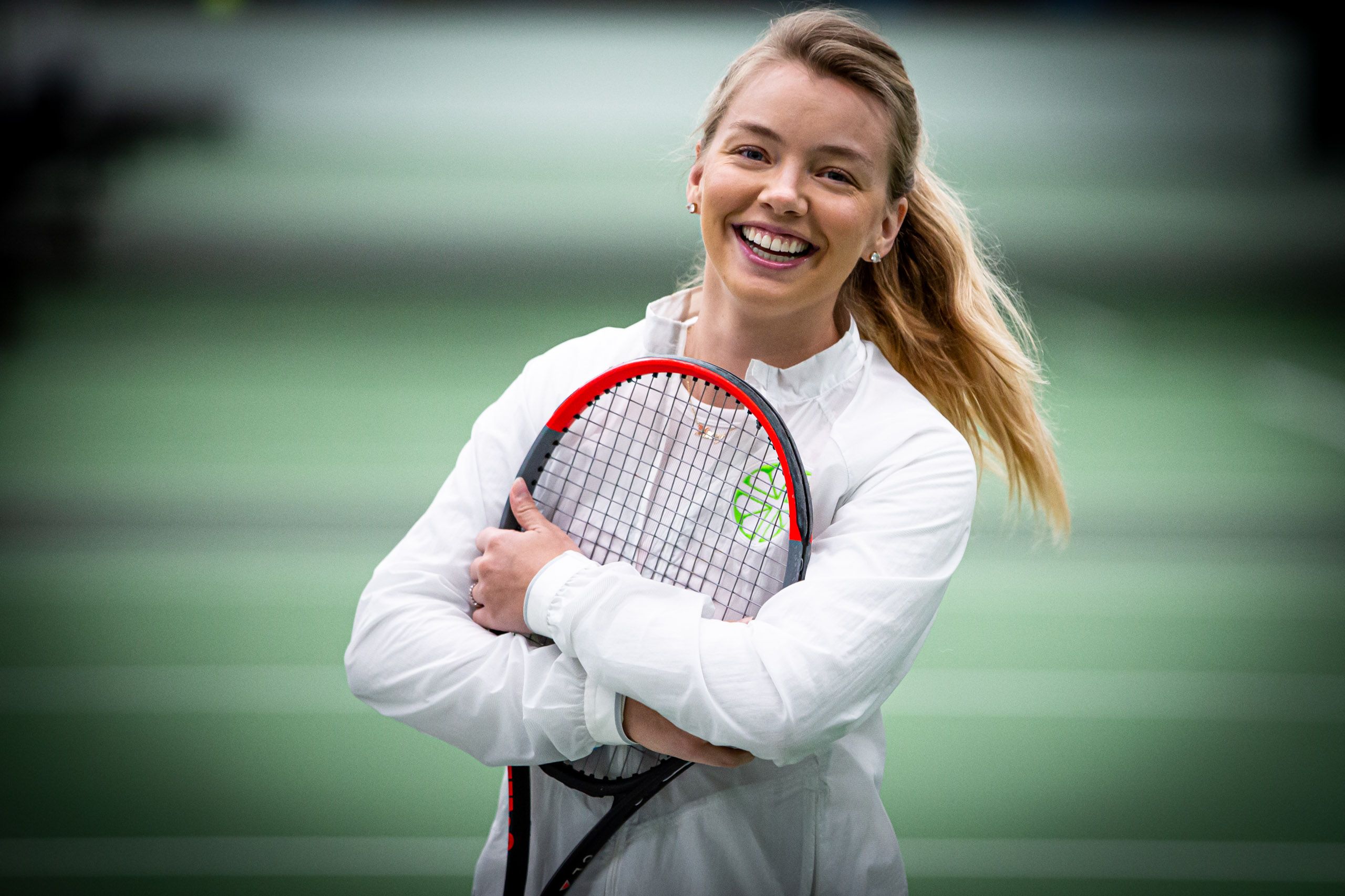 Woman Smiling with Tennis Racket