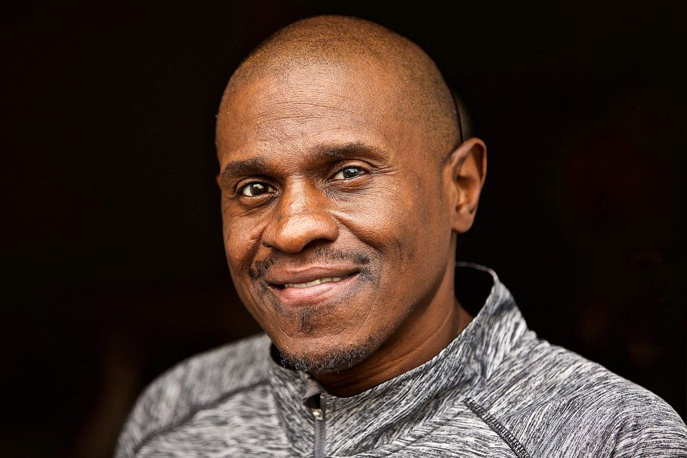A environmental portrait of a man smiling looking into the camera. Photographed in St. Louis. Photographed for a United Way advertising campaign. I am a advertising photographer, on location photographer & location commercial photographer. Photo of one of the many people that the United Way is assisting. Photo of Man Smiling Looking into Camera