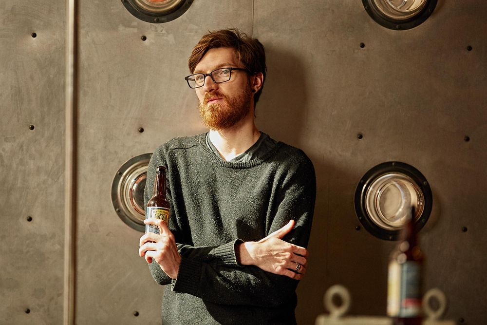A creative art director takes a break, deep in though and having a non-alcoholic beer doing the shoot. Art Director Reflects on the Creative