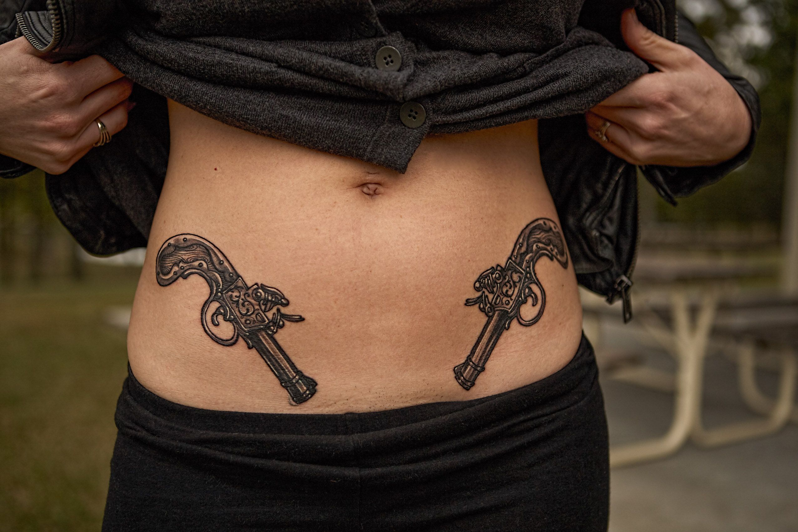 Woman with Gun Tattoos