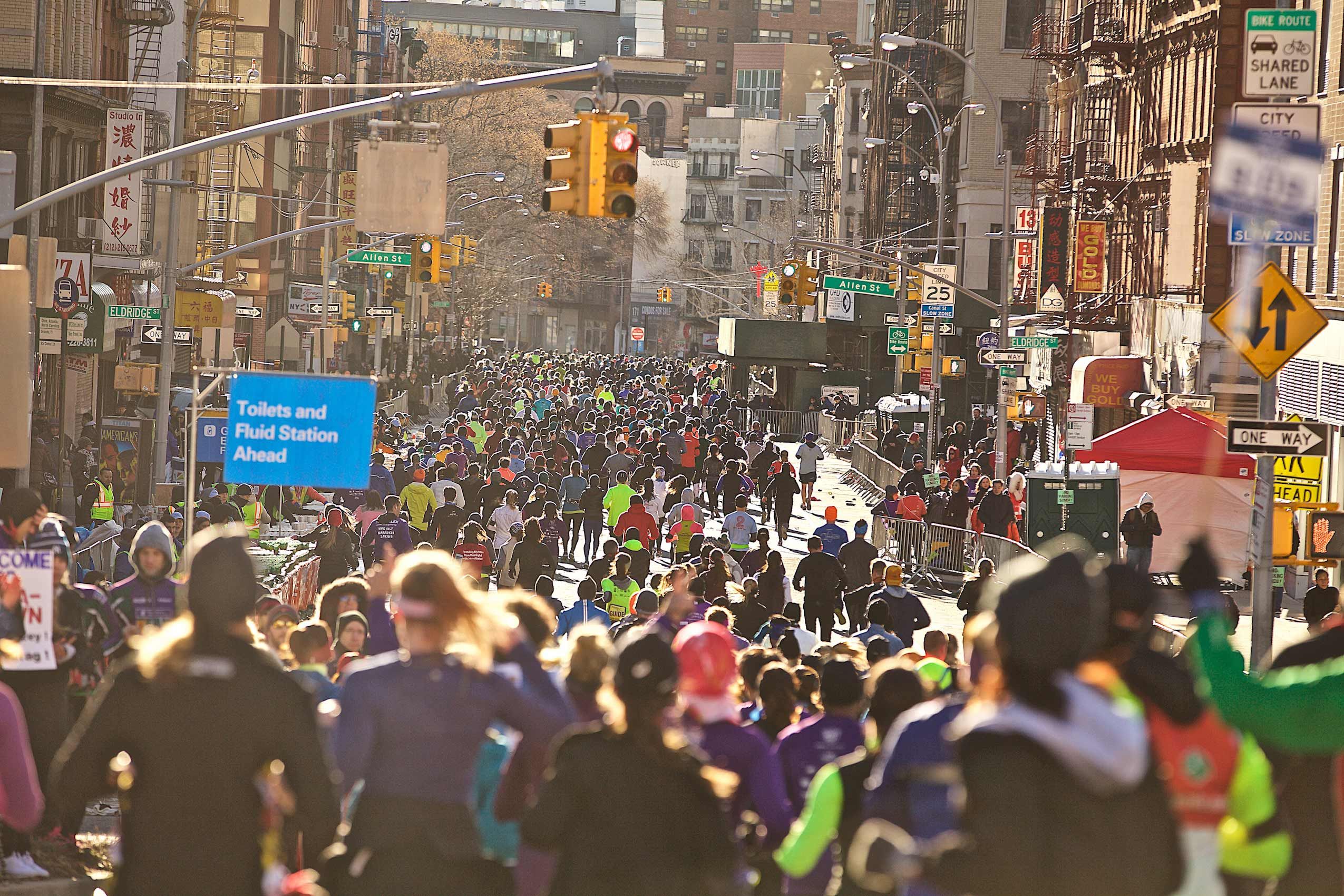 Wide shot from behind of the NYC Half Marathon in Chinatown.