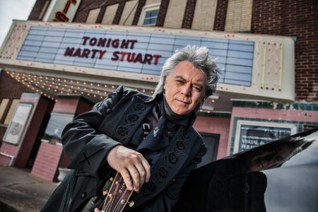 Portrait of Mary Stuart in front of a venue, theatre where he is headlining. Photograph shot in his home town of Philadelphia, MS. Photo shot form low angle, Mary Stuart is looking into the camera with a nice serious expression. Shot for the Mississippi Tourism campaign for advertising, branding, collateral and broadcast motion assets. Environmental portrait, and we are a industrial photographer, on location photographer & location commercial photographer. Shallow depth of field and selective focus. VisitMS Portrait of Marty Stuart