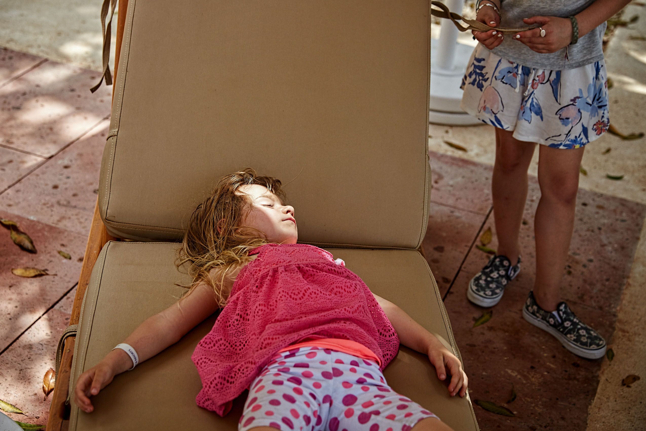 Young Girl Takes Nap on Pool Chair