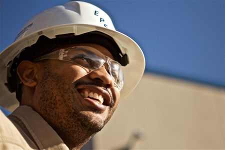 Industrial Electrician wearing a hard hat and smiling. Industrial Electrician