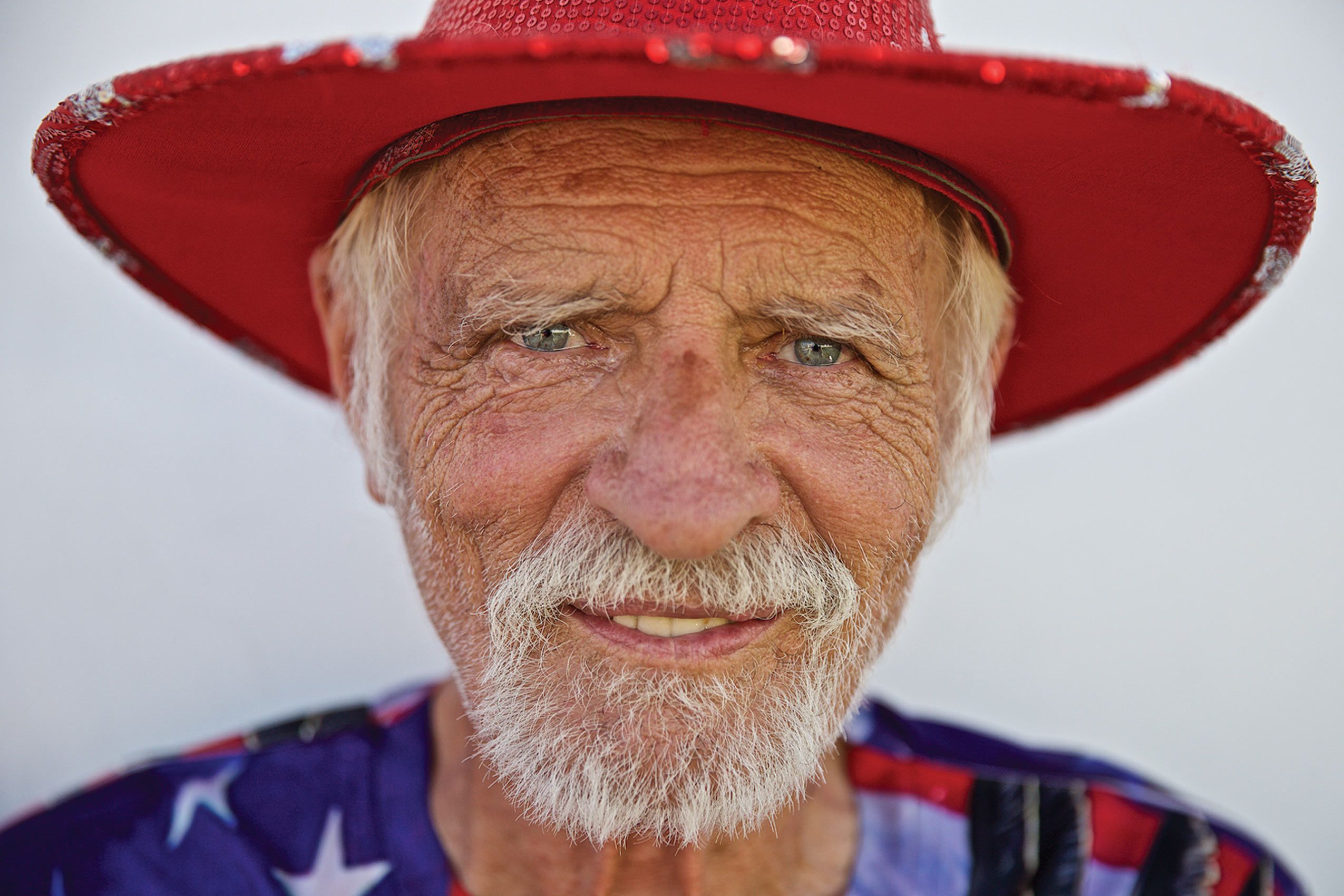 Head Shot of Man Smiling Dressed In Red White & Blue Colors