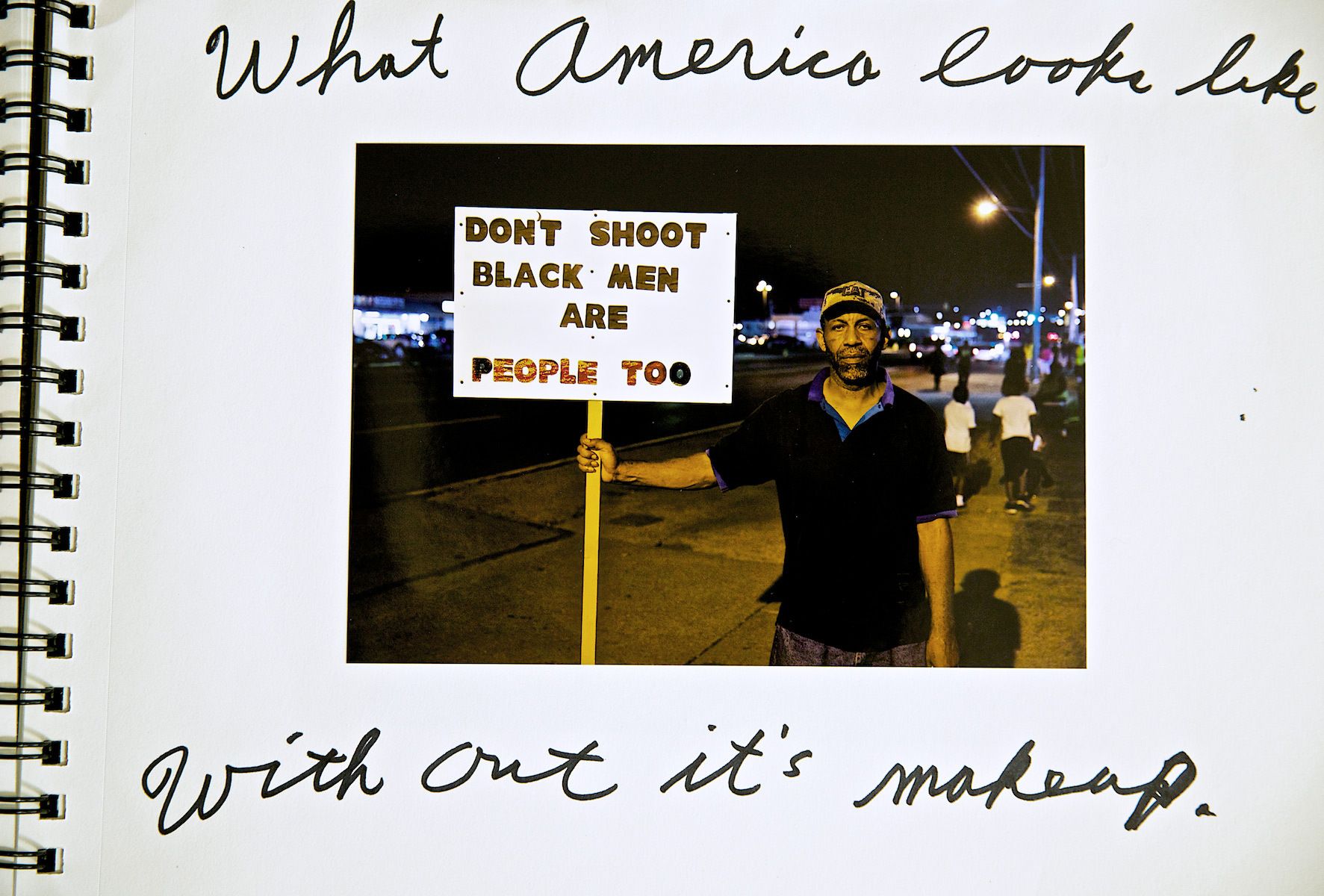 Man Protesting During the Riots With Sign
