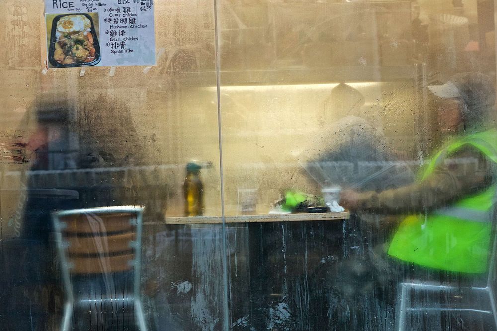 A volunteer for the NYC Half Marathon in Chinatown having an early morning break before the start of the race. Breakfast Before the Marathon