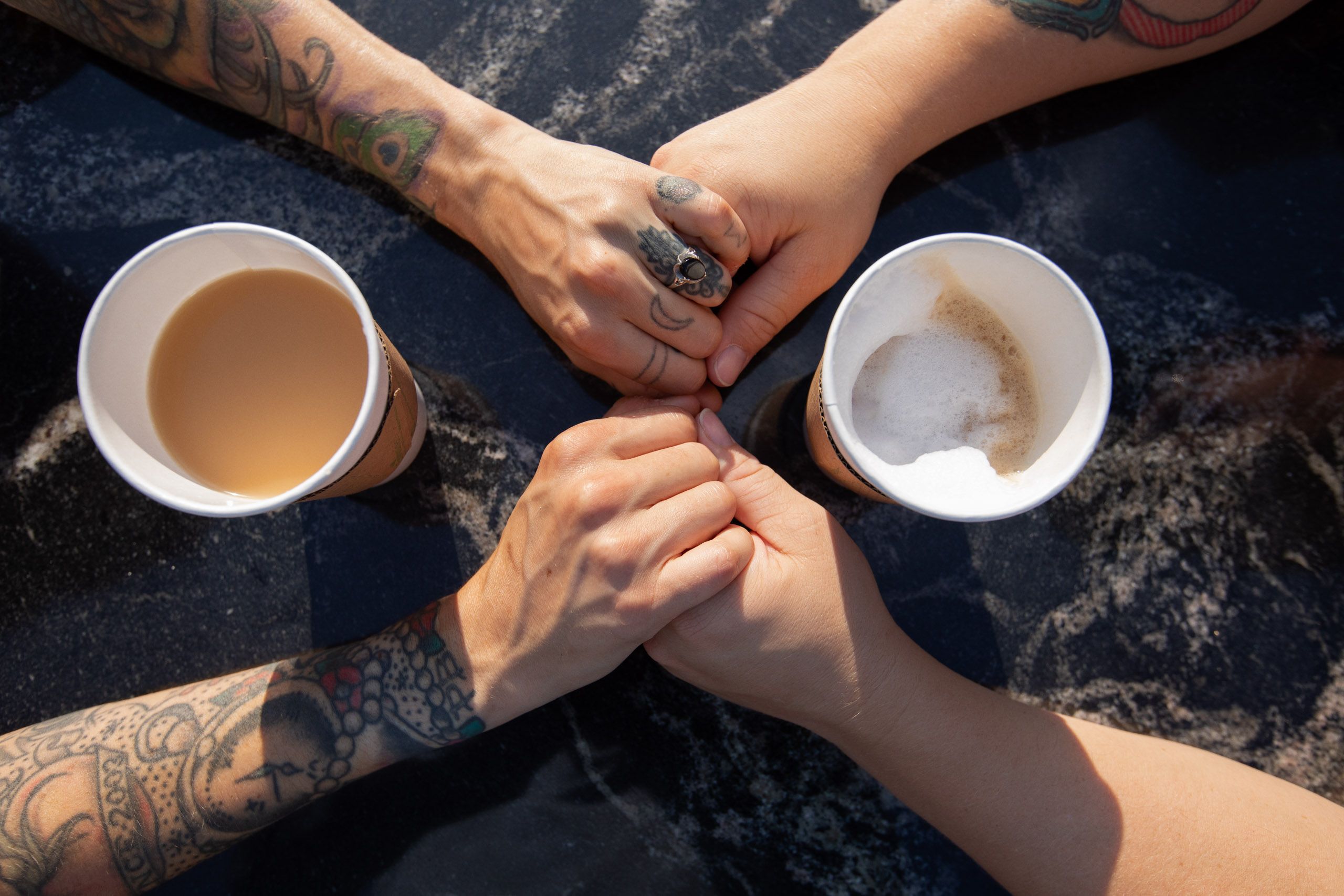Couple at Coffee Holding Hands