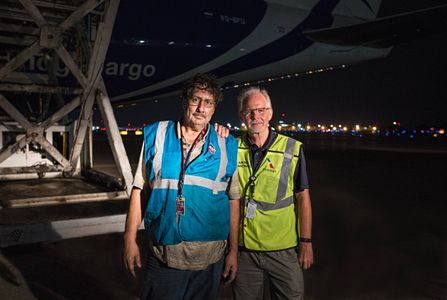 Environmental portrait of two workers, colleagues wearing protective vests, looking into the camera, standing in front of a Boeing 747-8 Freighter airplane. Next stop, the other side of the world! This was a project shooting for the air cargo transportation industry. This project was amazing as an industrial photographer, on location photographer & location commercial photographer.
Shot with shallow depth of field and selective focus. Environmental Portrait of Two Cargo Workers at Airport