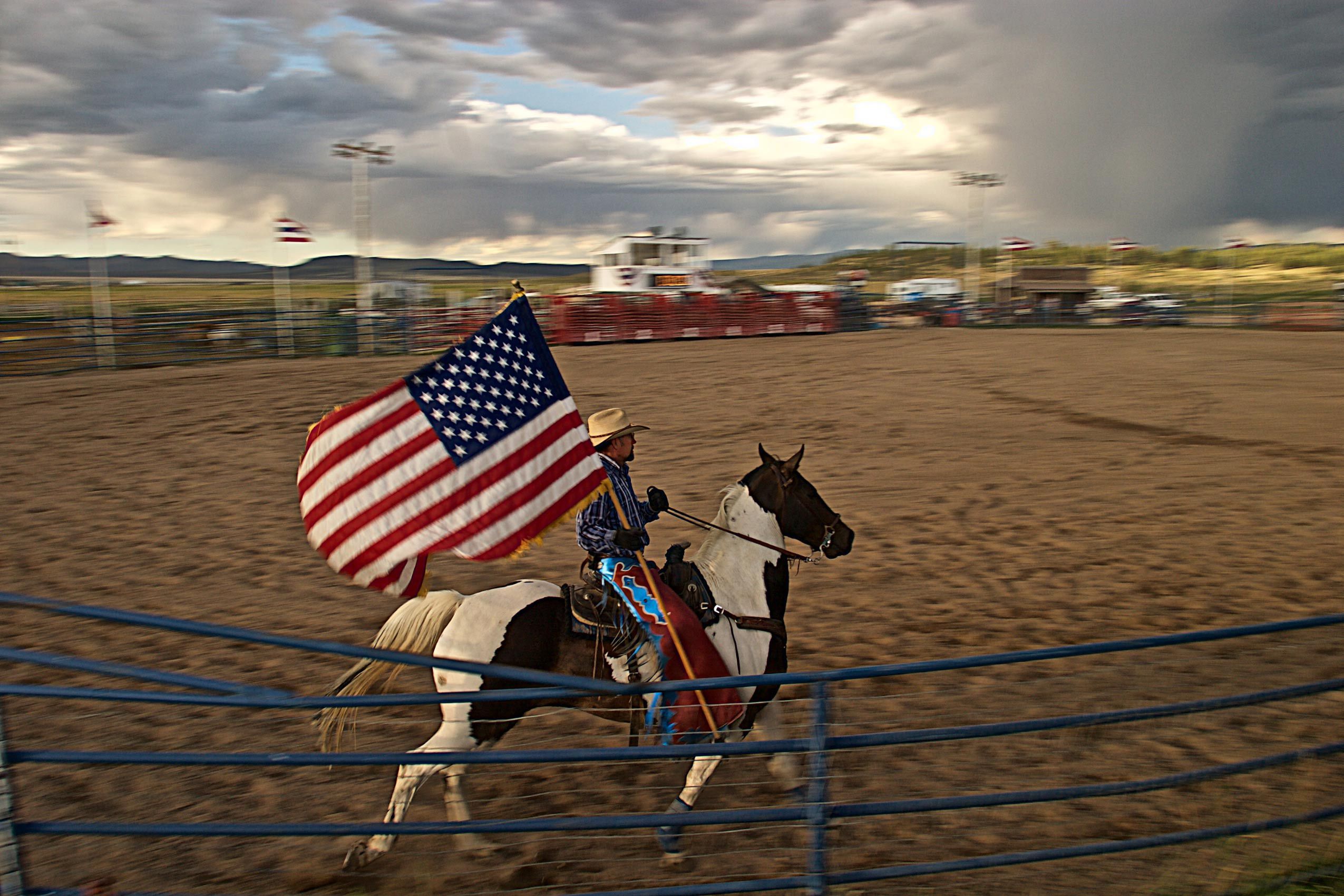 Rodeo Rider Holding an American Flag